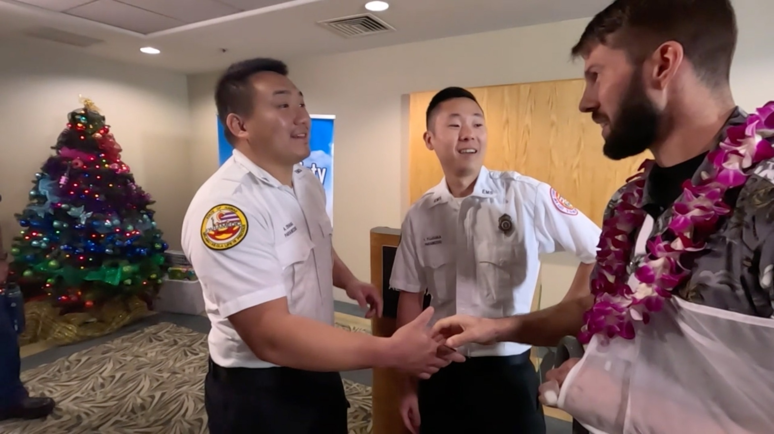 PHOTO: Ian Snyder, 34, meets on Dec. 12, 2023, some of the Honolulu EMS paramedics who helped rescue him after he survived a 1,000-foot fall from a hiking trail in Hawaii.