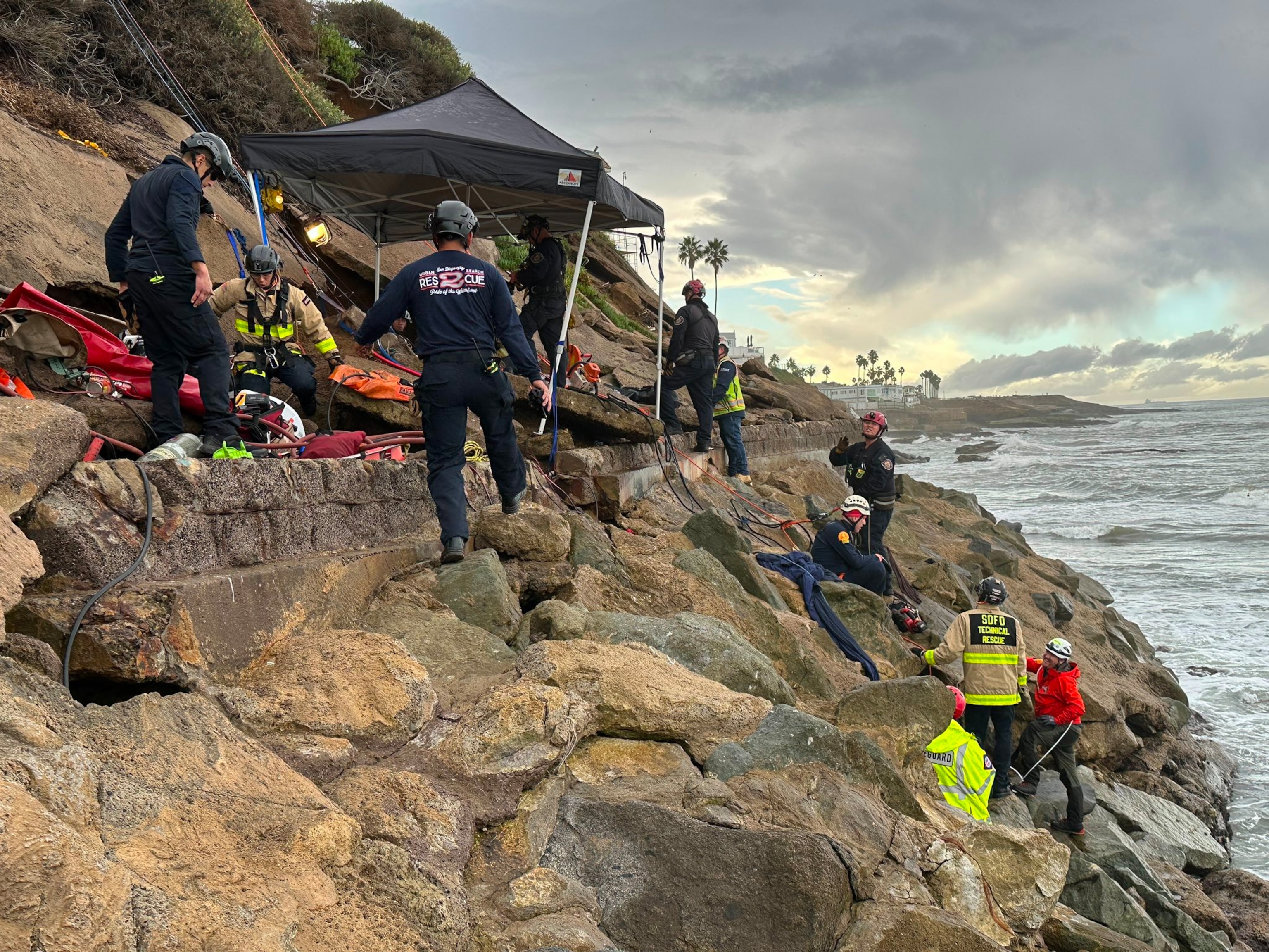 PHOTO: In a post made to their X account, the San Diego Fire-Rescue team is seen working to rescue a man who became trapped under broken concrete in the San Diego community of Sunset Cliffs, Dec. 22, 2023.