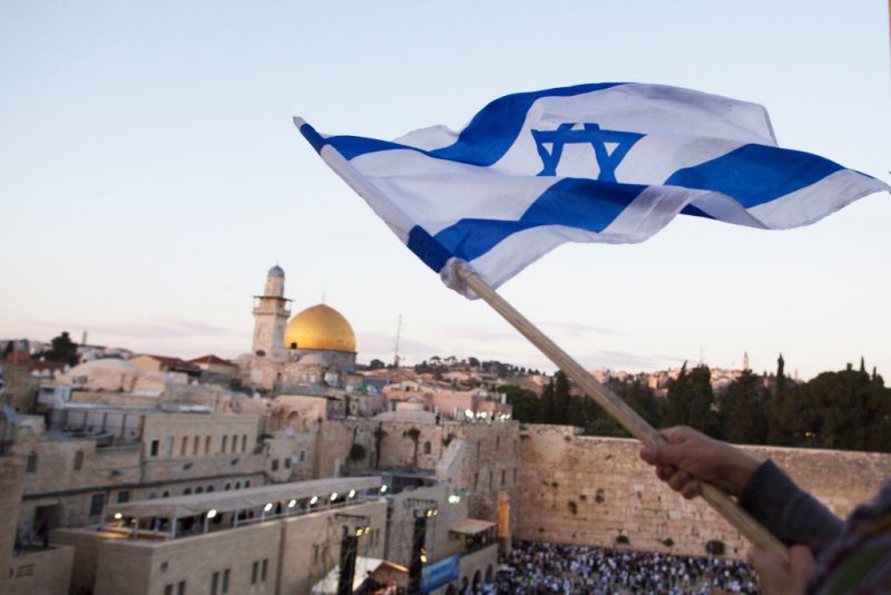 JERUSALEM, ISRAEL - MAY 13: (ISRAEL OUT) Israelis wave their national flags during a march next to the Western Wall on May 13, 2018 in Jerusalem, Israel. Israel mark Jerusalem Day celebrations the 51th anniversary of its capture of Arab east Jerusalem in the Six Day War of 1967. One day before US will move the Embassy to Jerusalem. (Photo by Lior Mizrahi/Getty Images)