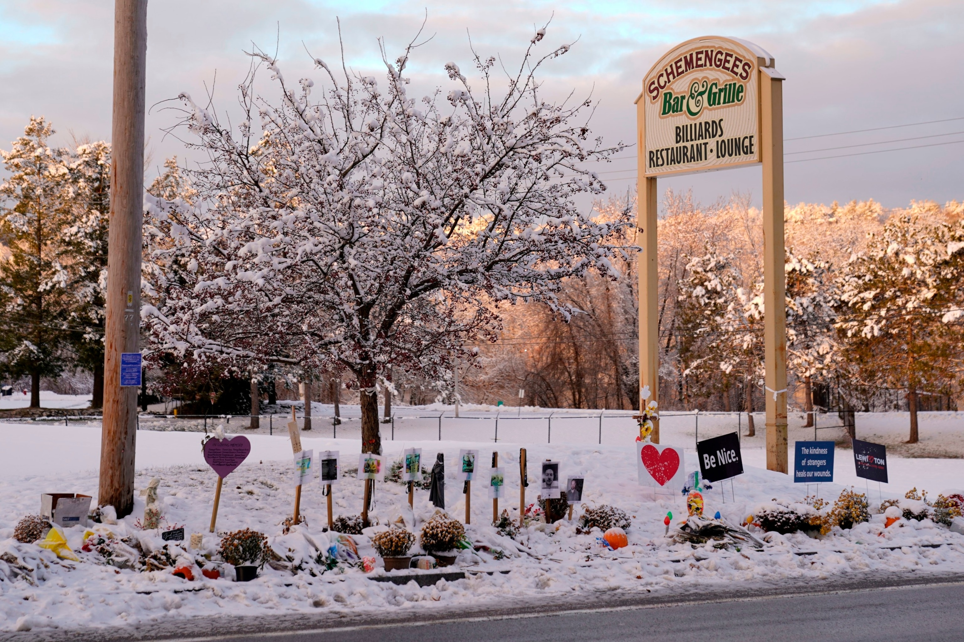 PHOTO: Snow accumulates outside a restaurant at a makeshift memorial for the victims of last month's mass shooting in Lewiston, Maine, Dec. 5, 2023.