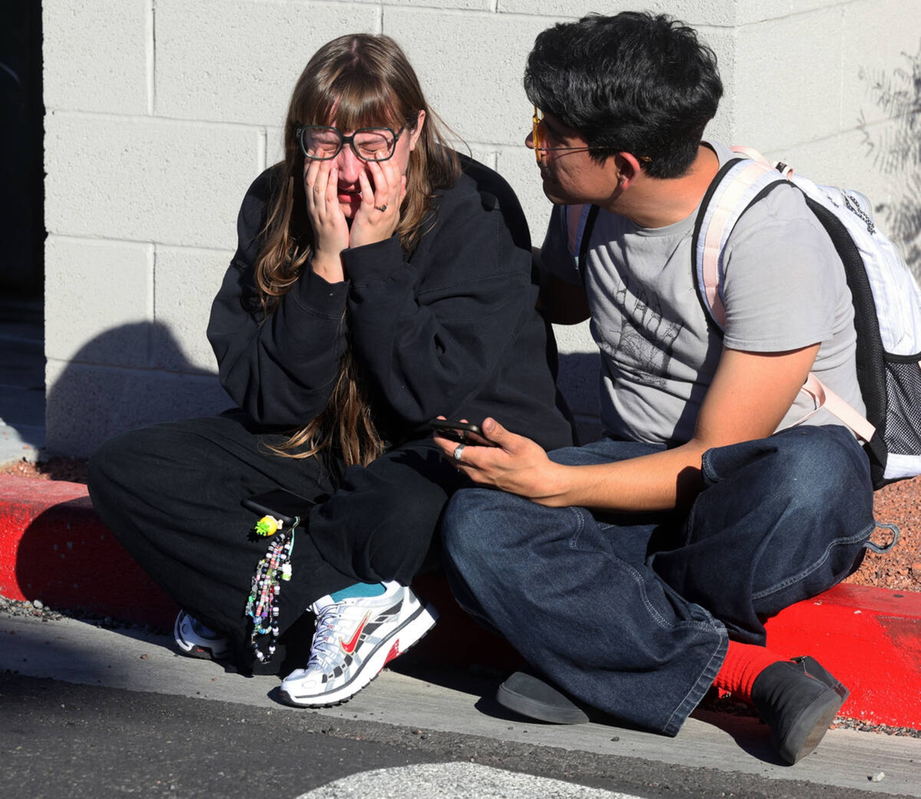 PHOTO: Amanda Perez is comforted by fellow student Alejandro Barron near Maryland Parkway following a shooting on the UNLV campus in Las Vegas, Dec. 6, 2023.