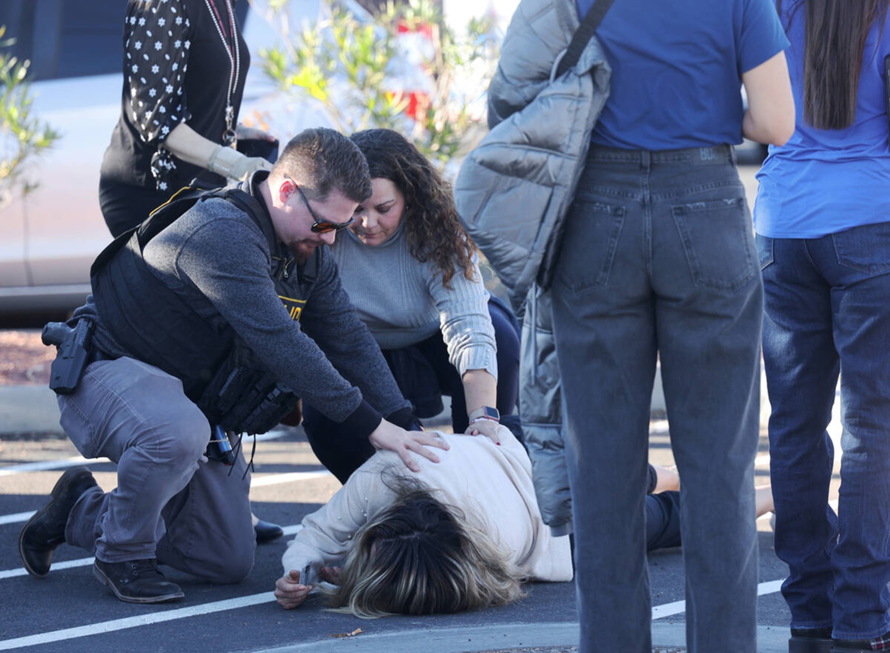 PHOTO: Police attend to a person near Maryland Parkway following a shooting on the UNLV campus, Dec. 6, 2023, in Las Vegas. 