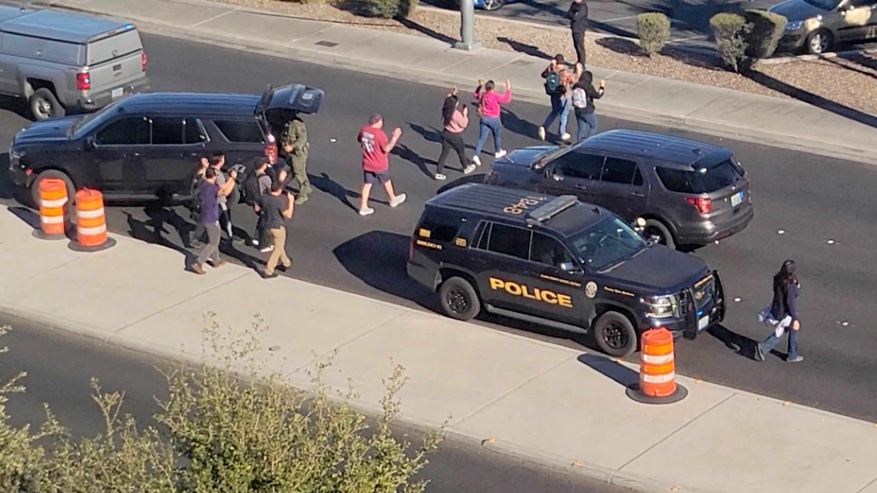 PHOTO: People leave campus with raised hands following reports of a shooting at the University of Nevada, in the campus of Las Vegas, on Dec. 6, 2023, in this screen grab taken from a handout video. 