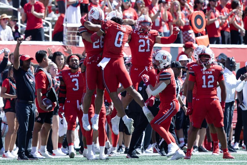 SALT LAKE CITY, UT - SEPTEMBER 16: Logan Fano #0 of the Utah Utes celebrates a fumble recovery with teammates Sione Vaki #28 and Karene Reid #21 against during the second half of their game against the Weber State Wildcats at Rice-Eccles Stadium September 16, 2023 in Salt Lake City, Utah. (Photo by Chris Gardner/Getty Images)