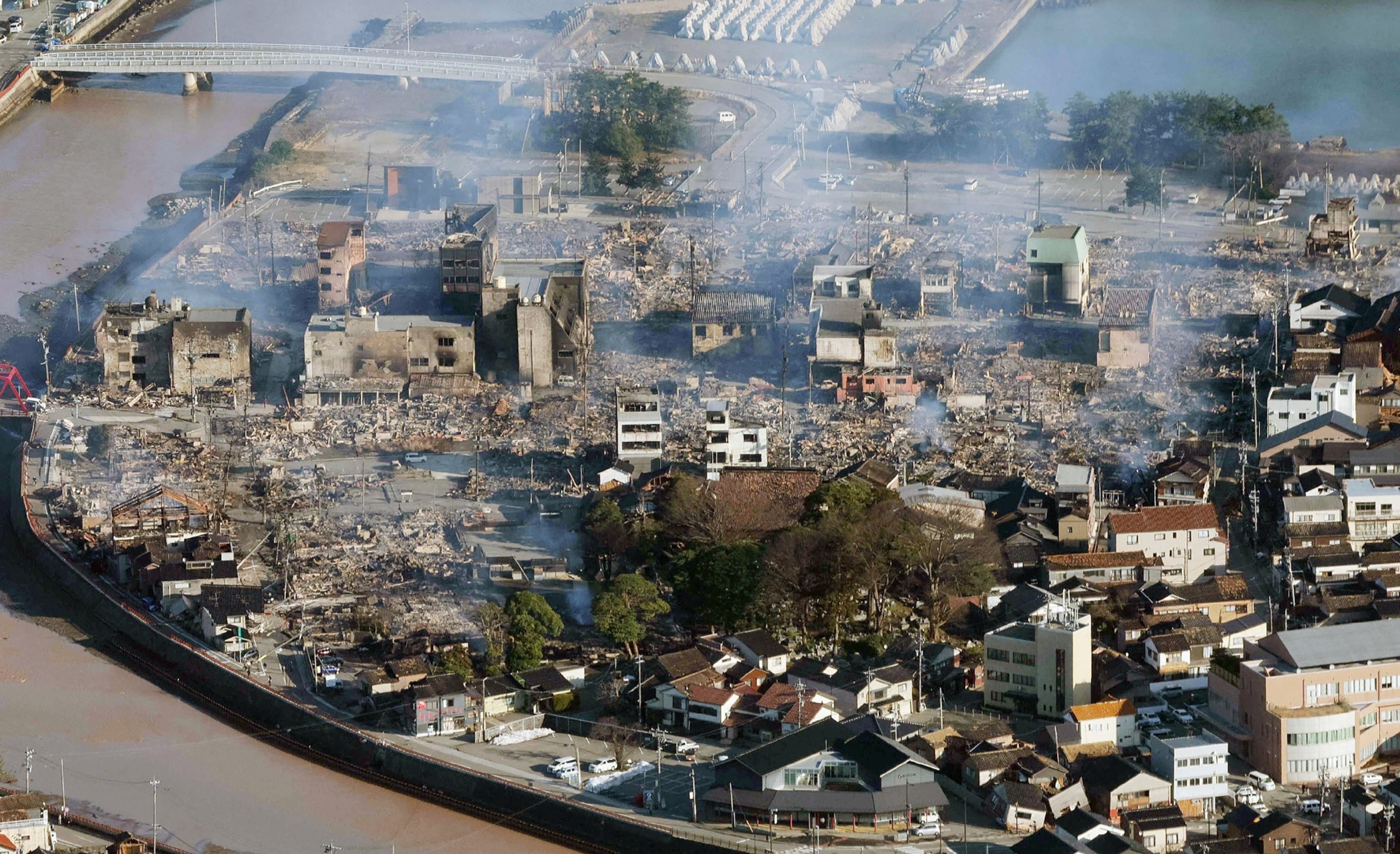 PHOTO: This aerial photo provided by Jiji Press shows smoke rising from an area following a large fire in Wajima, Ishikawa prefecture on January 2, 2024, a day after a major 7.5 magnitude earthquake struck the Noto region in Ishikawa prefecture 