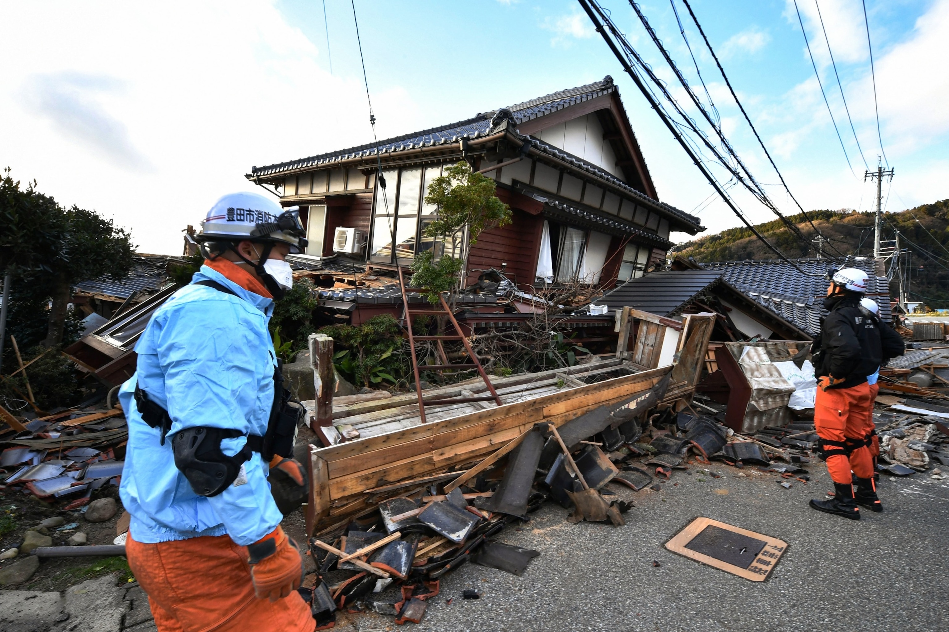 PHOTO: Firefighters inspect collapsed wooden houses in Wajima, Ishikawa Prefecture, on Jan. 2, 2024, a day after a major 7.5 magnitude earthquake struck the Noto region in the prefecture in the afternoon.