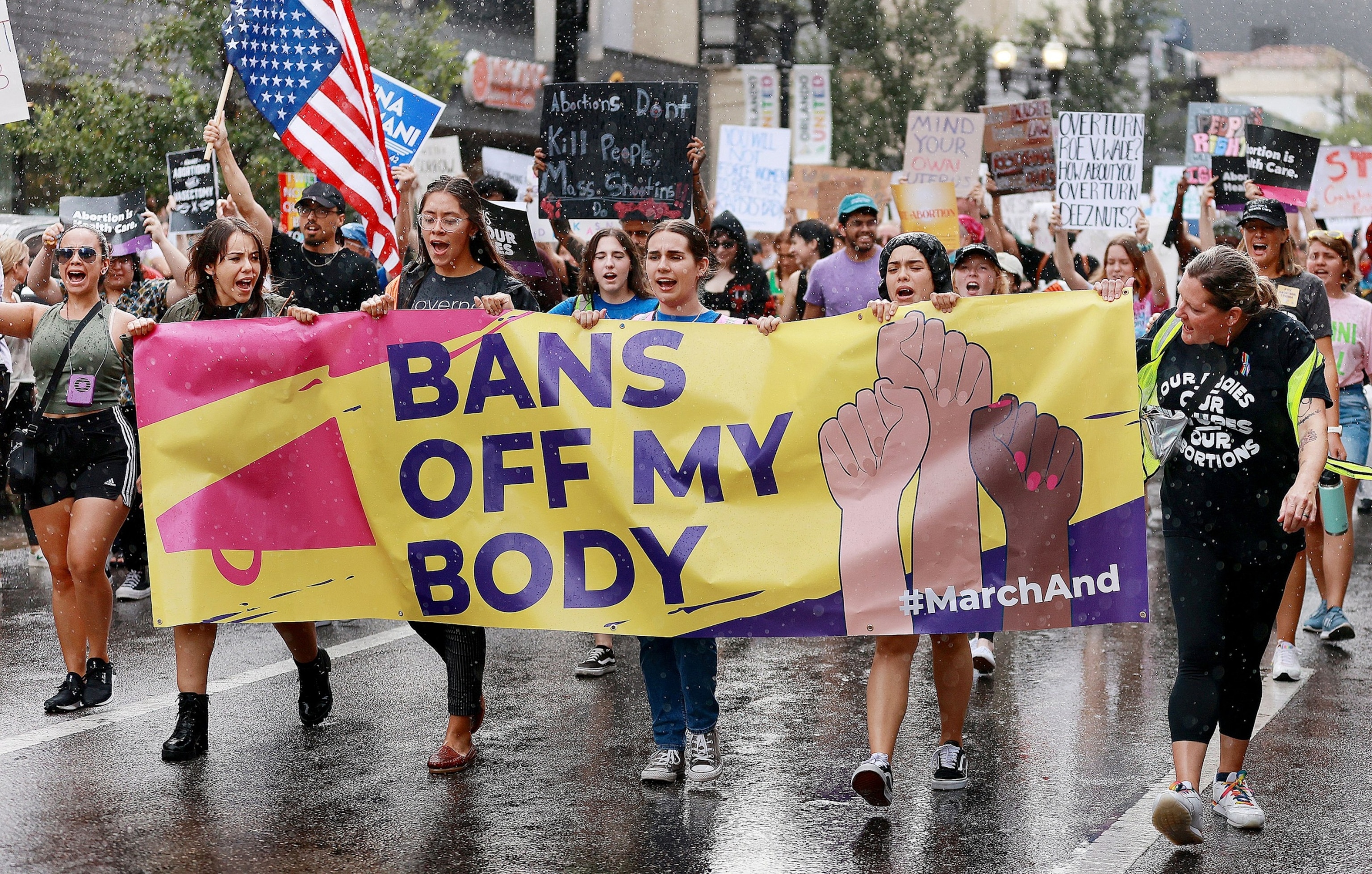 PHOTO: Demonstrators march in the rain during an abortion rights rally in downtown Orlando, June 27, 2022.