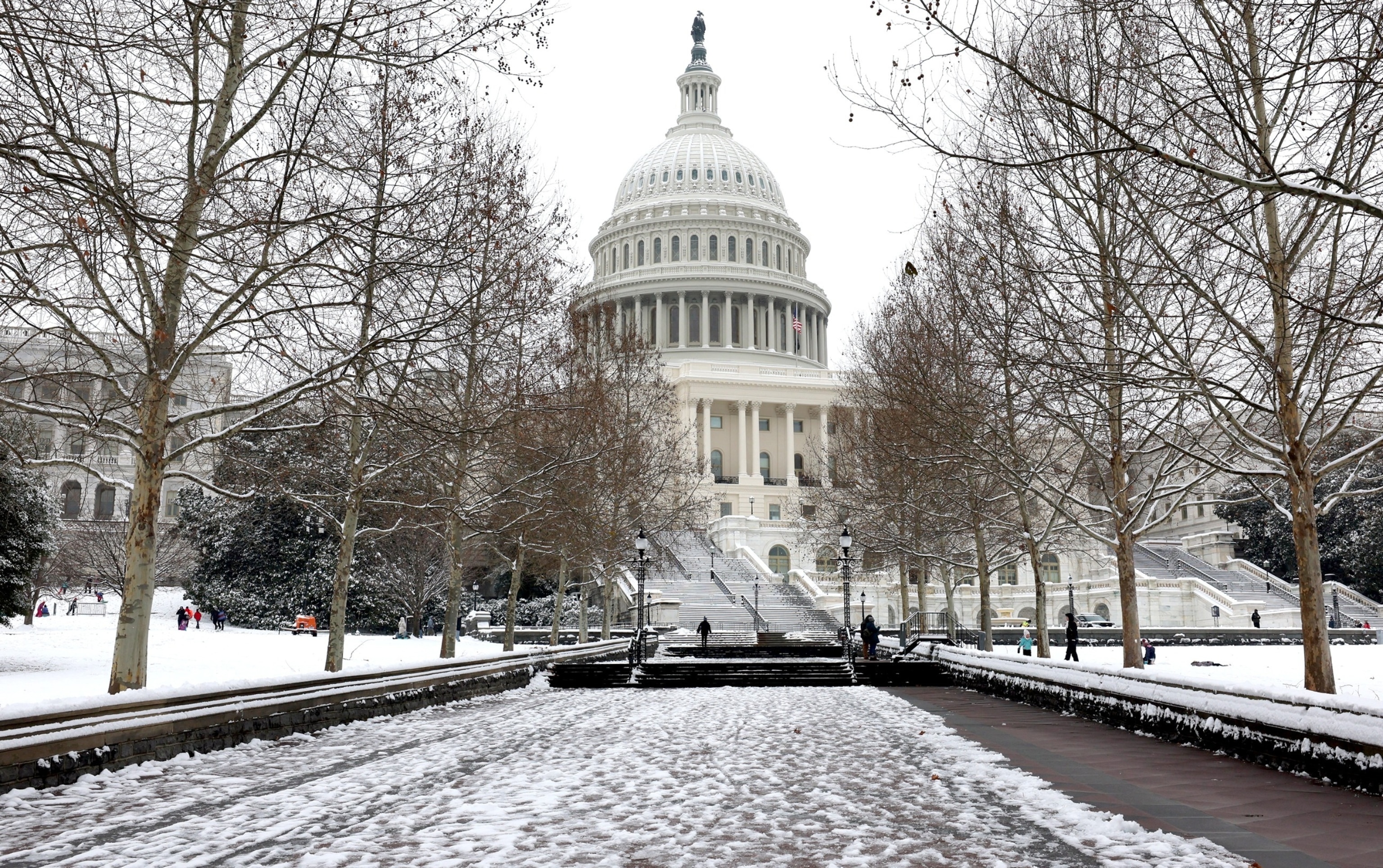 PHOTO: People enjoy the snow outside of the U.S. Capitol building in Washington, Jan. 16, 2024.