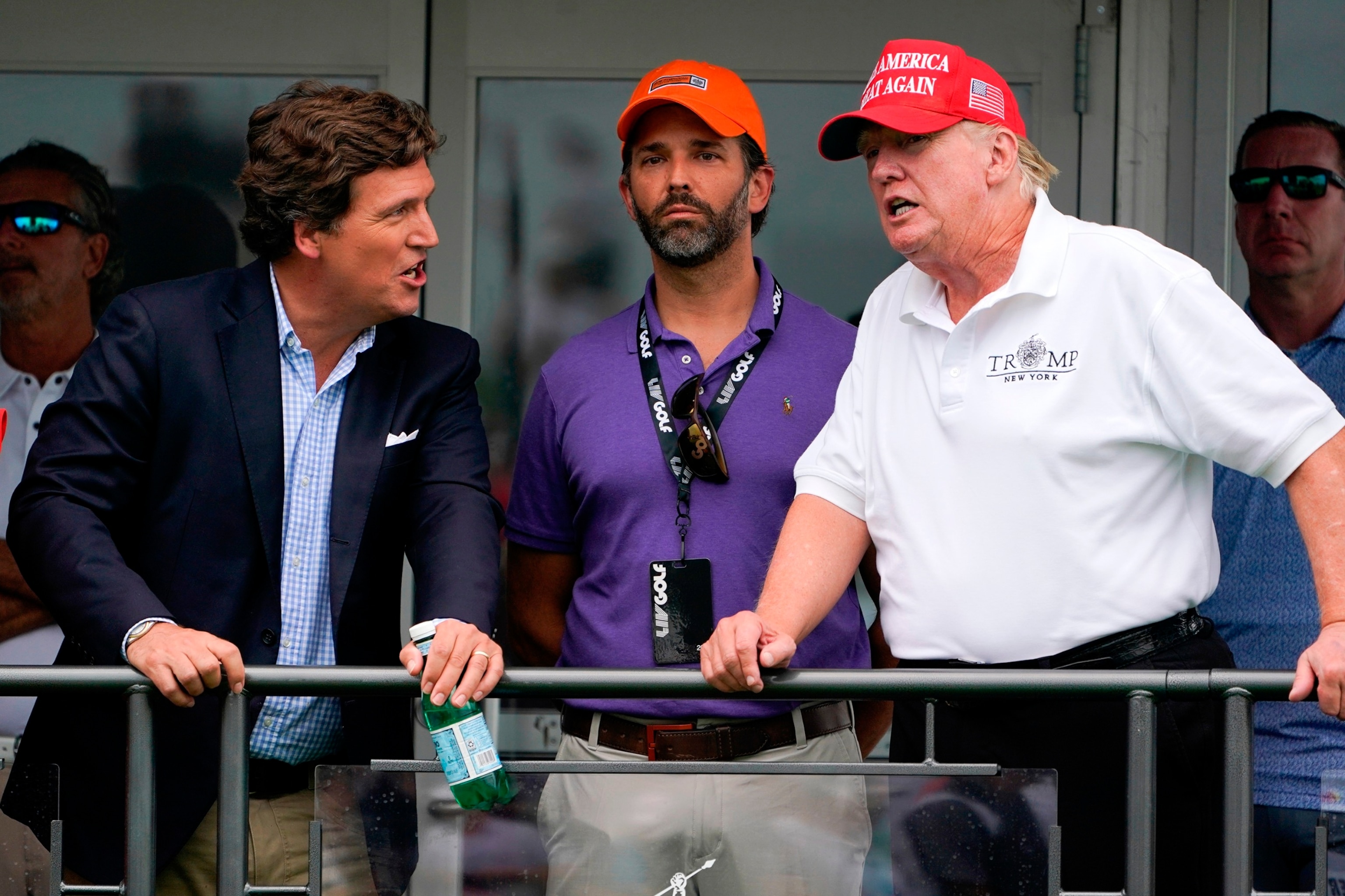 PHOTO: In this July 31, 2022, file photo, former President Donald Trump talks with Donald Trump Jr., and Tucker Carlson at the 16th tee during the final round of the Bedminster Invitational LIV Golf tournament in Bedminster, N.J.