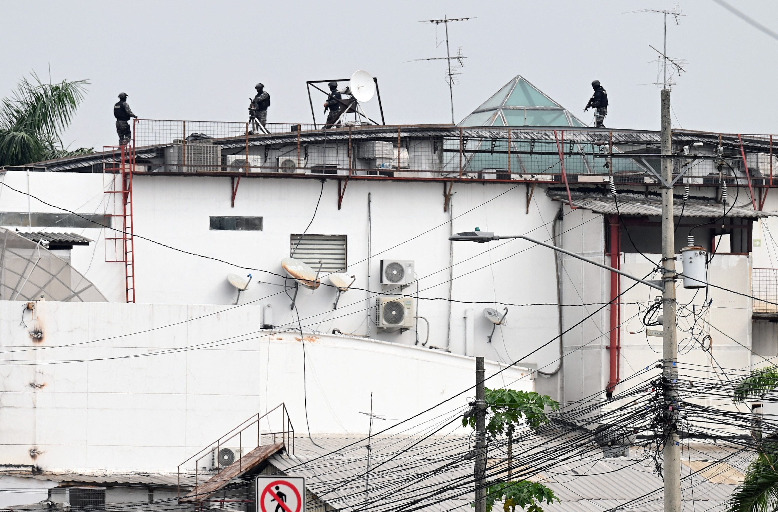 PHOTO: An Ecuadorean police squad approach the premises of Ecuador's TC television channel after unidentified gunmen burst into the state-owned television studio live on air on Jan. 9, 2024, in Guayaquil, Ecuado.