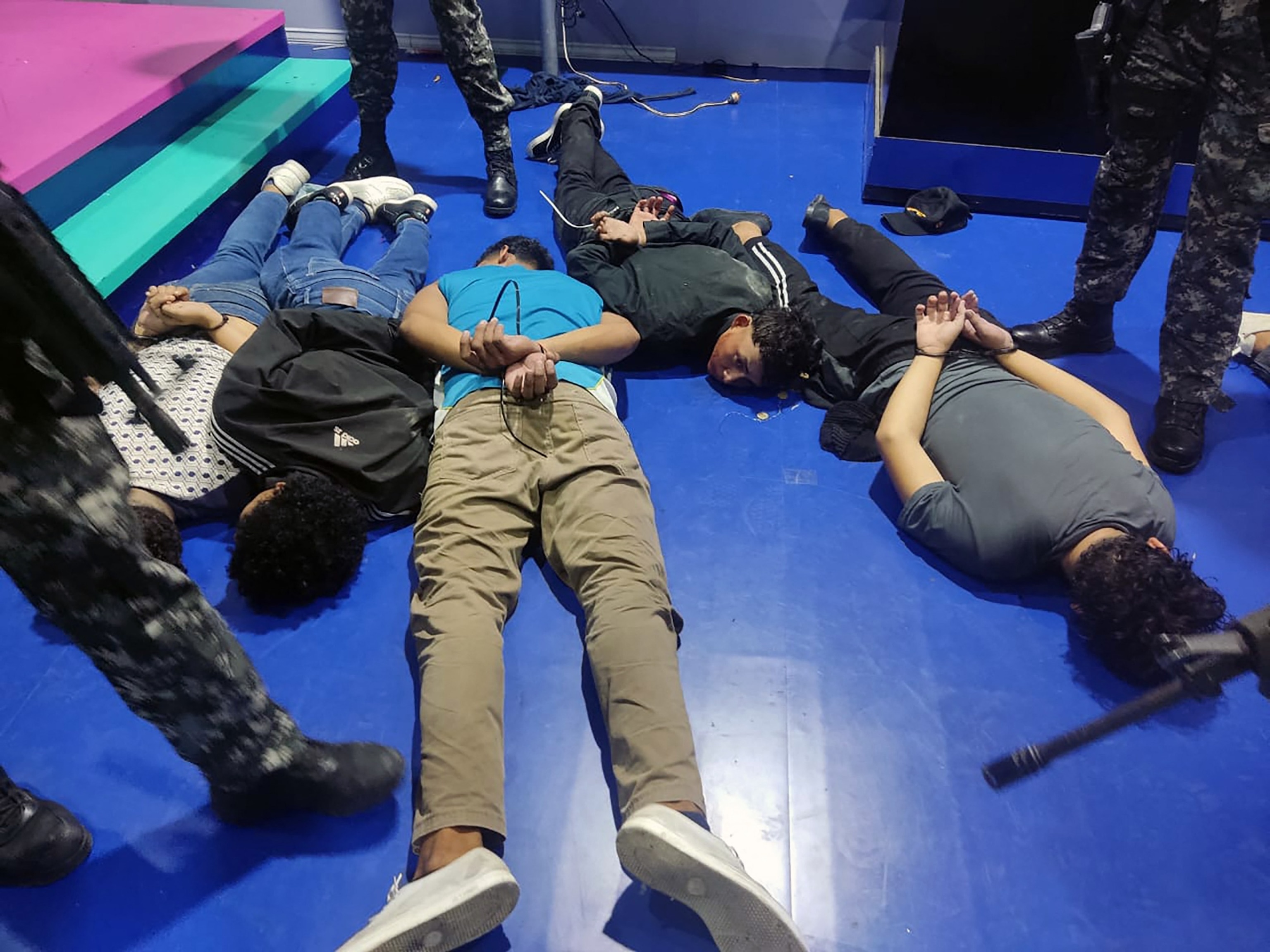 PHOTO: Suspects detained by police officers inside the studio of public television station TC who took hostage several journalists and staff members, in port city of Guayaquil, Ecuador, on Jan. 9, 2024.