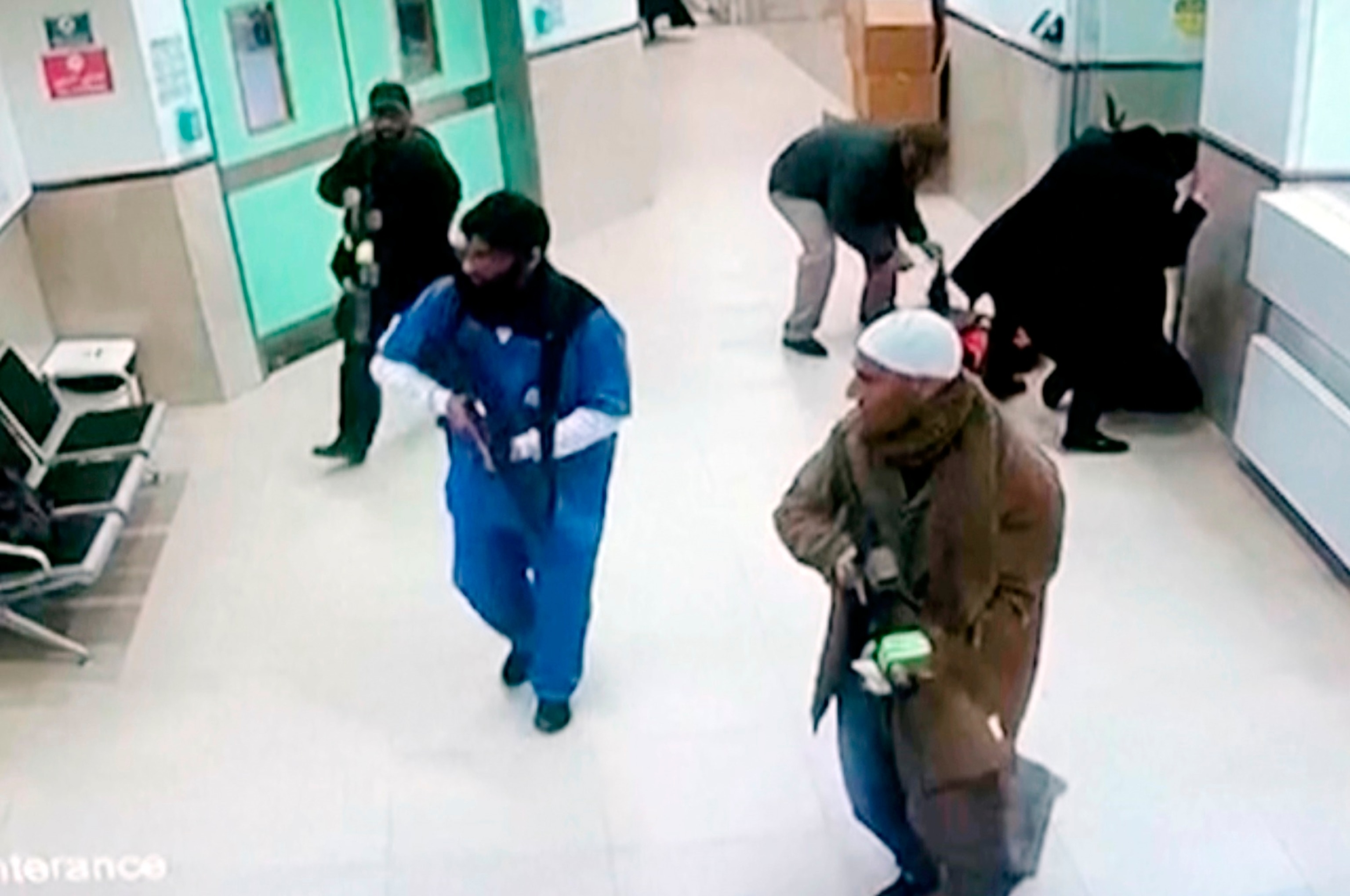 PHOTO: In this image taken from surveillance video provided by the Palestinian Health Ministry, Israeli forces disguised as civilians and medical workers hold weapons in a hallway at the Ibn Sina Hospital in the West Bank town of Jenin, Jan. 30, 2024.