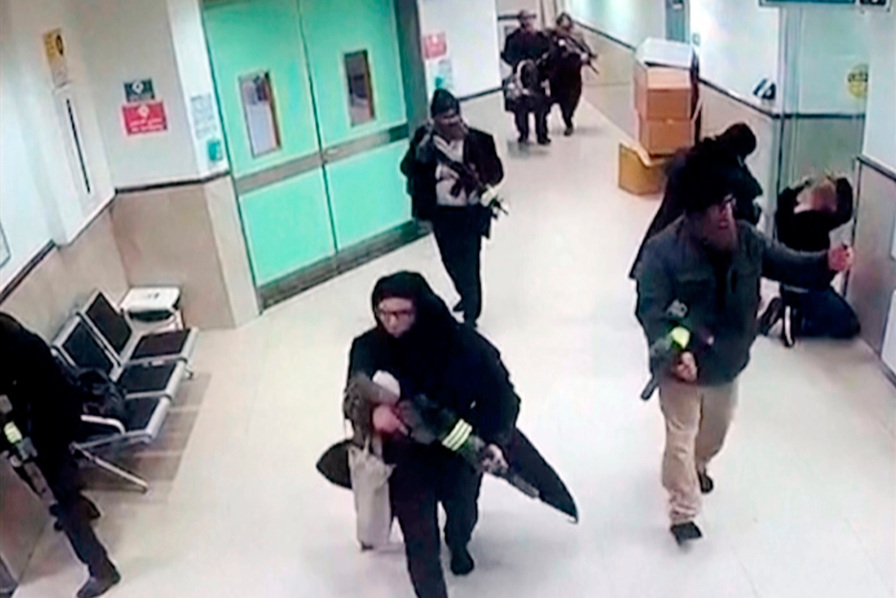 PHOTO: In this image taken from surveillance video provided by the Palestinian Health Ministry, Israeli forces disguised as civilian women and medical workers hold weapons in a hallway at the Ibn Sina Hospital in the West Bank town of Jenin, Jan. 30, 2024