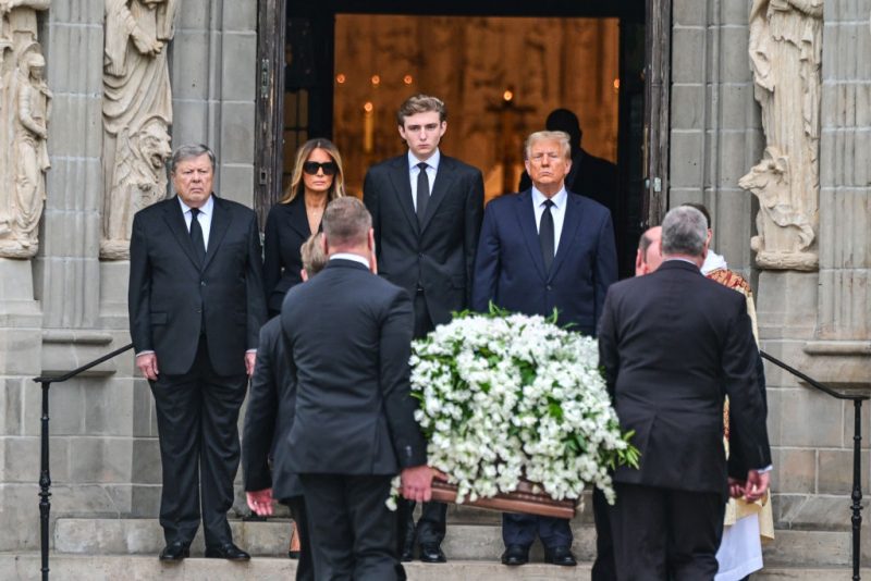 Former US President Donald Trump (center right) stands with his wife Melania Trump (2L) their son Barron Trump (center left) and father-in-law Viktor Knavs, as the coffin carrying the remains of Amalija Knavs, the former first lady's mother, is carried into the Church of Bethesda by the Sea for her funeral, in Palm Beach, Florida, on January 18, 2024. Former first lady Melania Trump's mother Amalija Knavs, 78, died January 9, 2024 in Miami following an undisclosed illness. (Photo by GIORGIO VIERA / AFP) (Photo by GIORGIO VIERA/AFP via Getty Images)