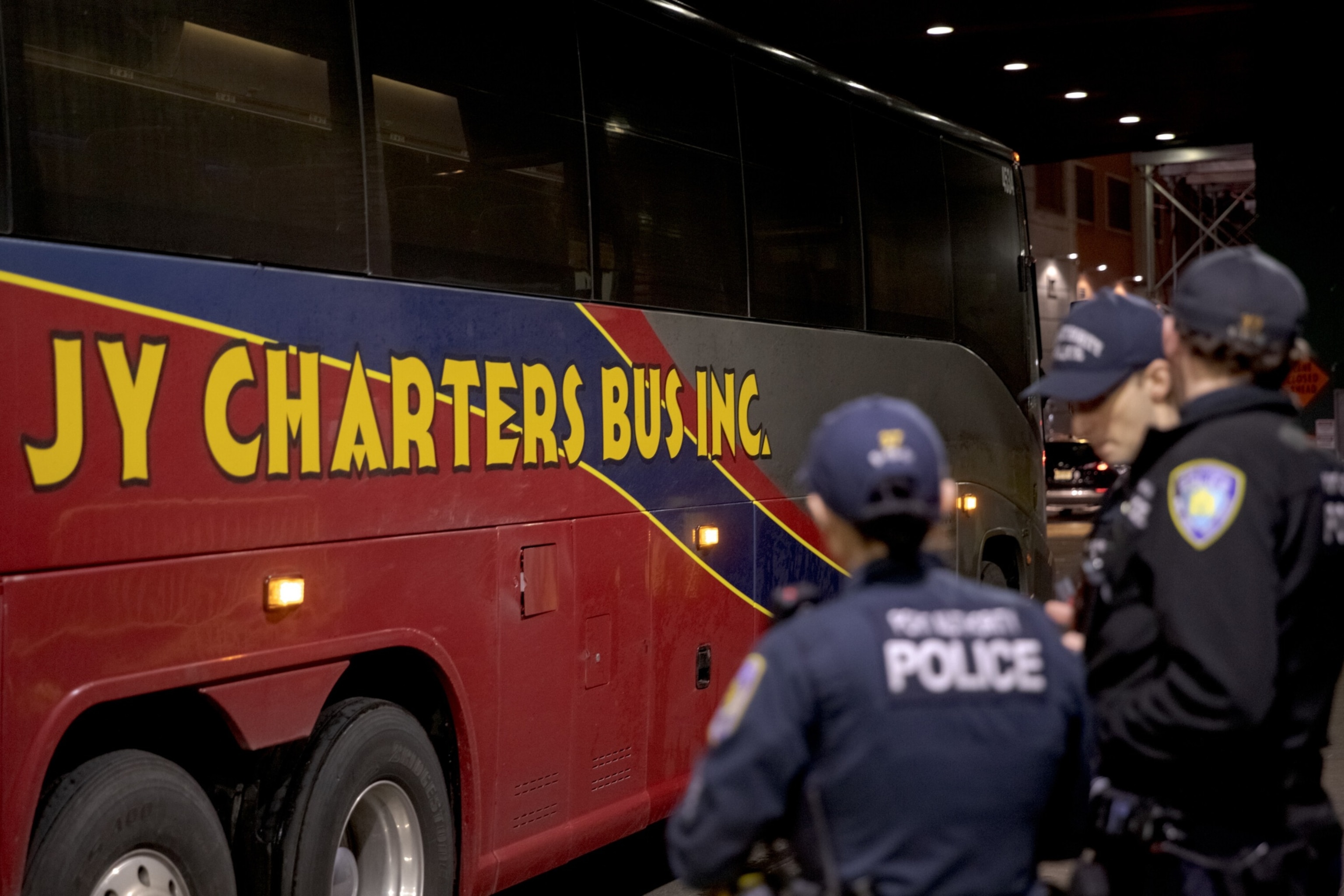 PHOTO: Port Authority police stand by a charter bus that had brought migrants from Texas to Manhattan, on Dec. 28, 2023. 