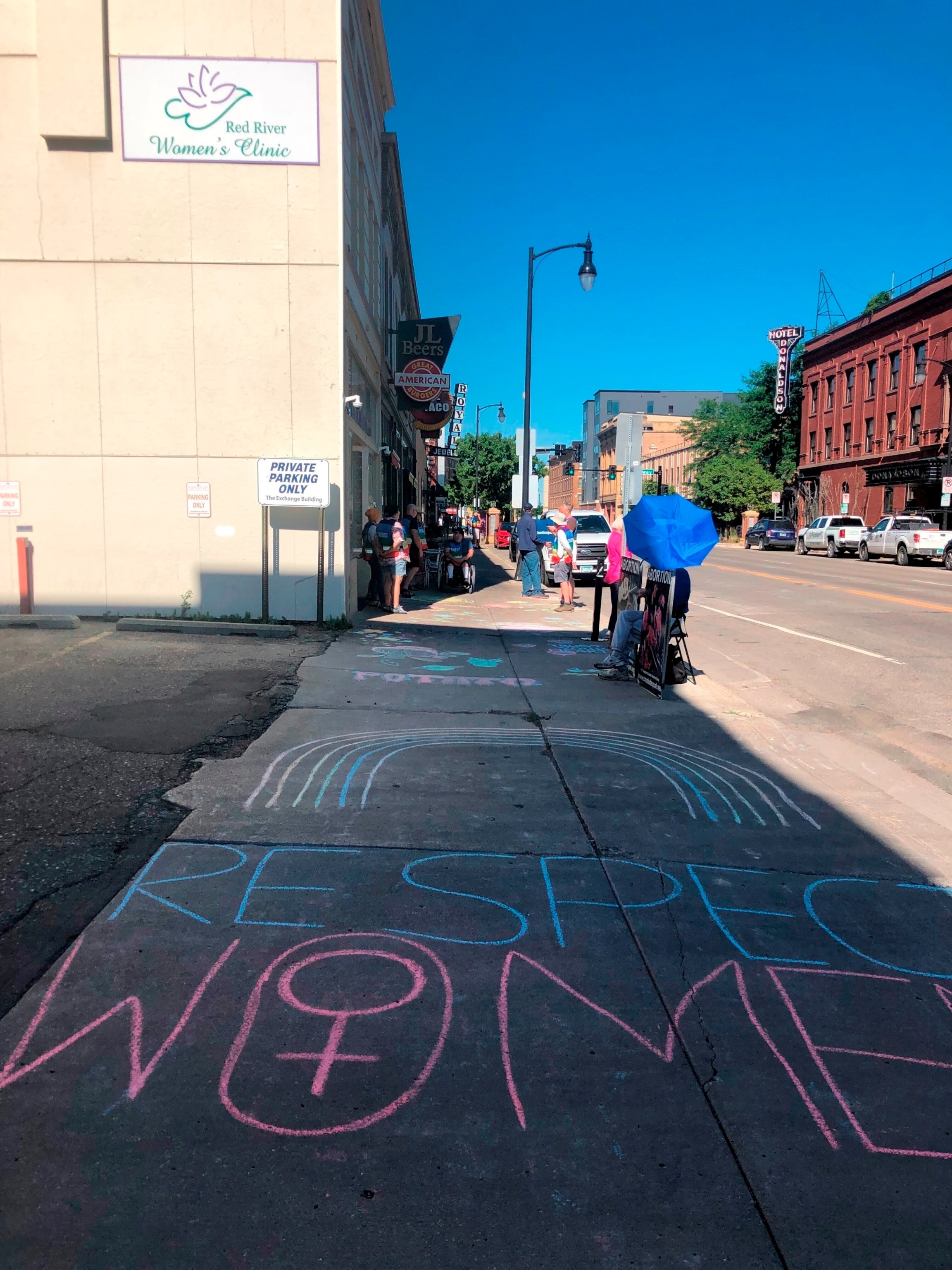 PHOTO: Abortion protesters used chalk to draw messages and artwork on the sidewalk leading to the entrance of the Red River Women's Clinic in downtown Fargo, N.D., July 27, 2022.