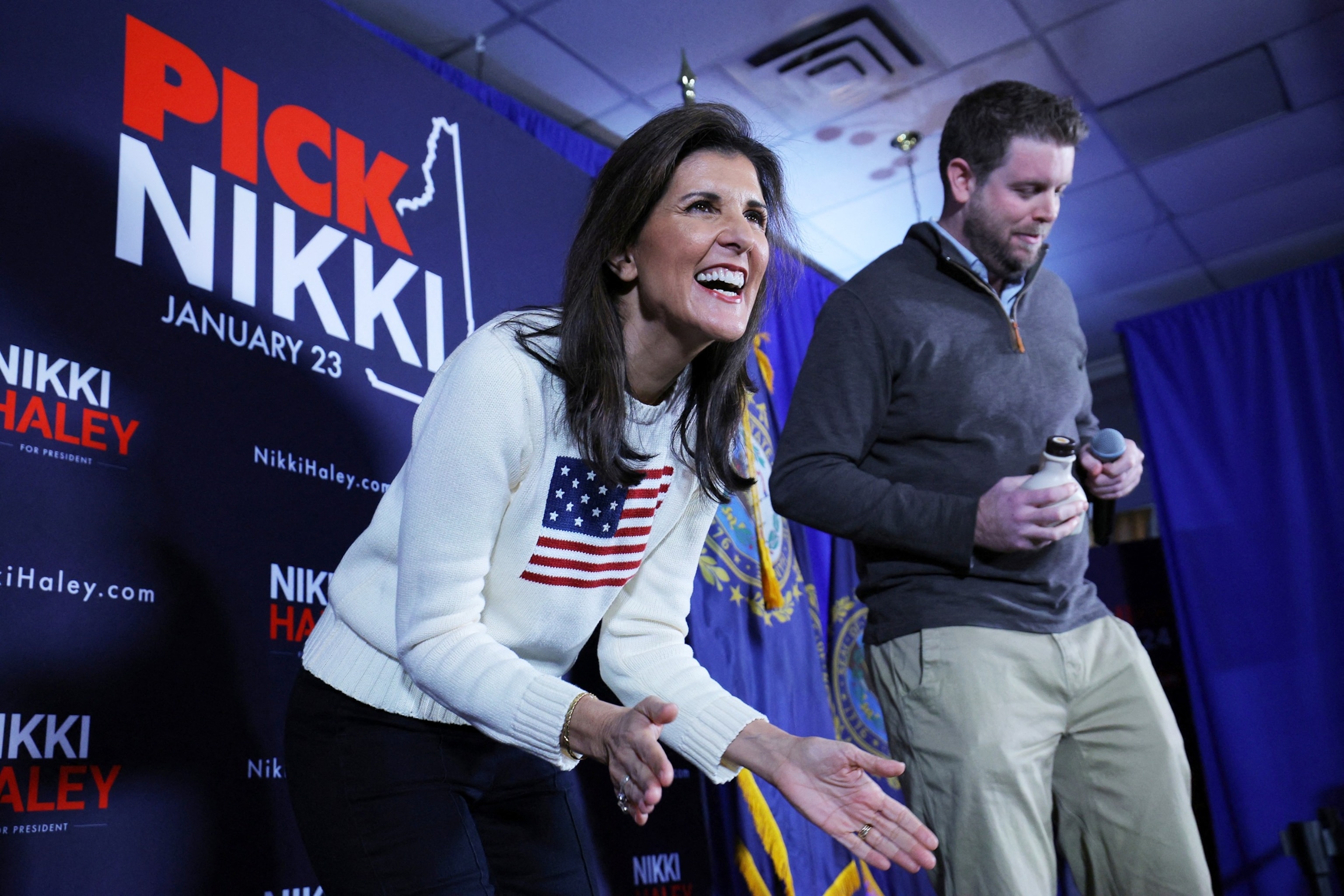 PHOTO: Republican presidential candidate Nikki Haley reacts as former Keene Mayor George Hansel presents her with a bottle of maple syrup for her birthday, at a campaign stop in Keene, N.H., on Jan. 20, 2024. 