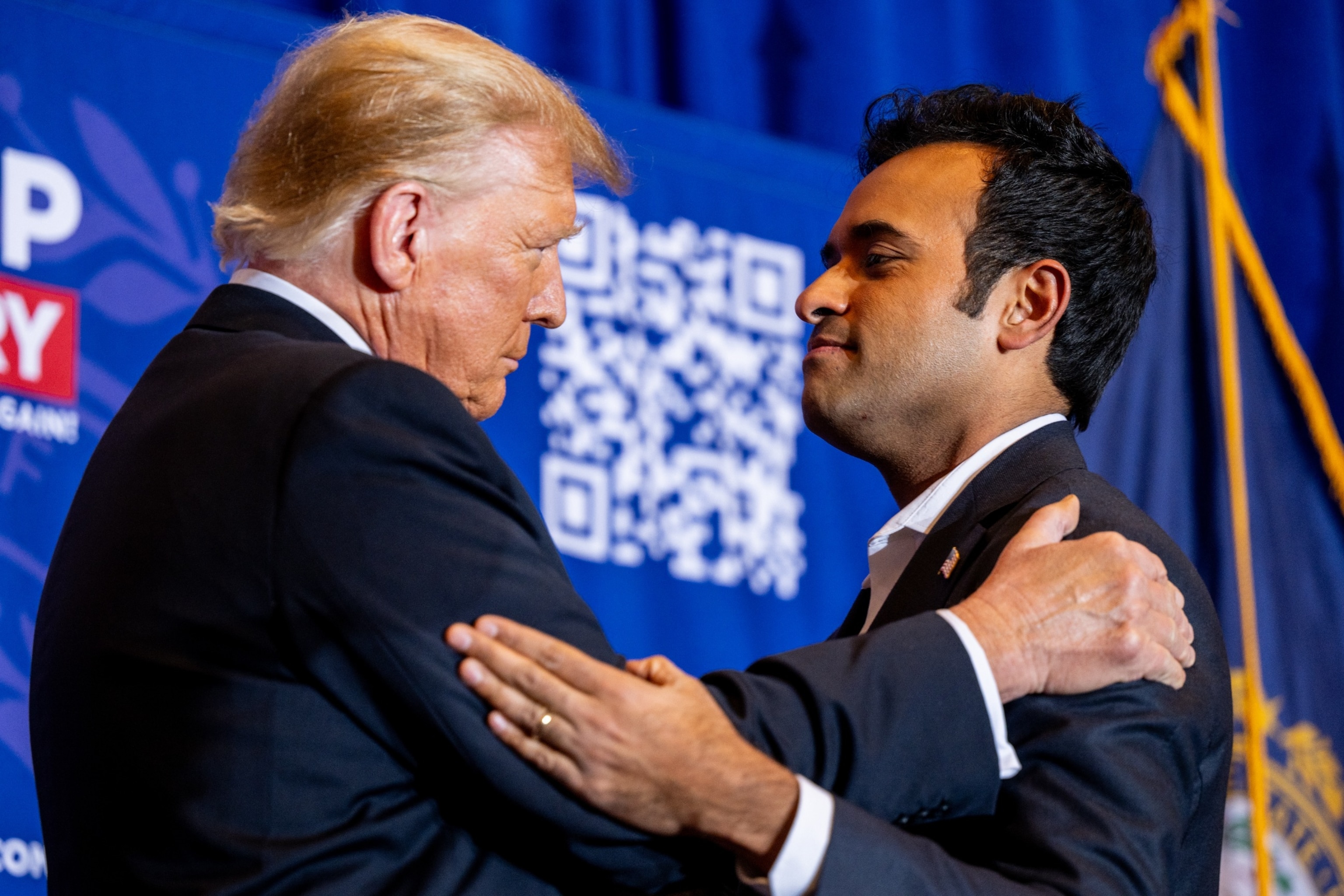 PHOTO: Republican presidential candidate, former U.S. President Donald Trump greets U.S. entrepreneur Vivek Ramaswamy while speaking during a campaign rally at the Atkinson Country Club on Jan. 16, 2024 in Atkinson, N. H.