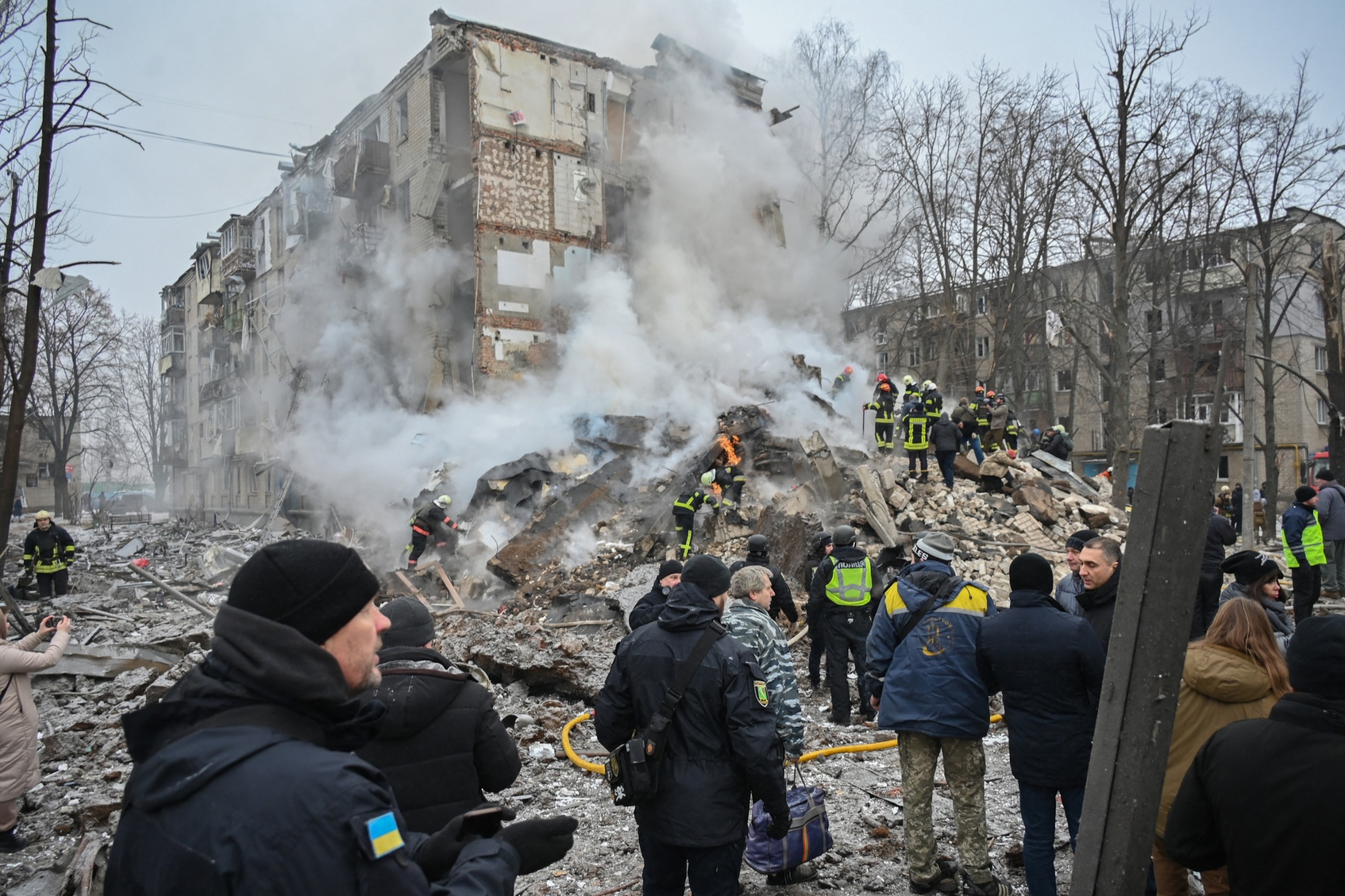 PHOTO: Ukrainian rescue and emergency workers attend the site of a missile attack in Kharkiv on Jan. 23, 2024. 