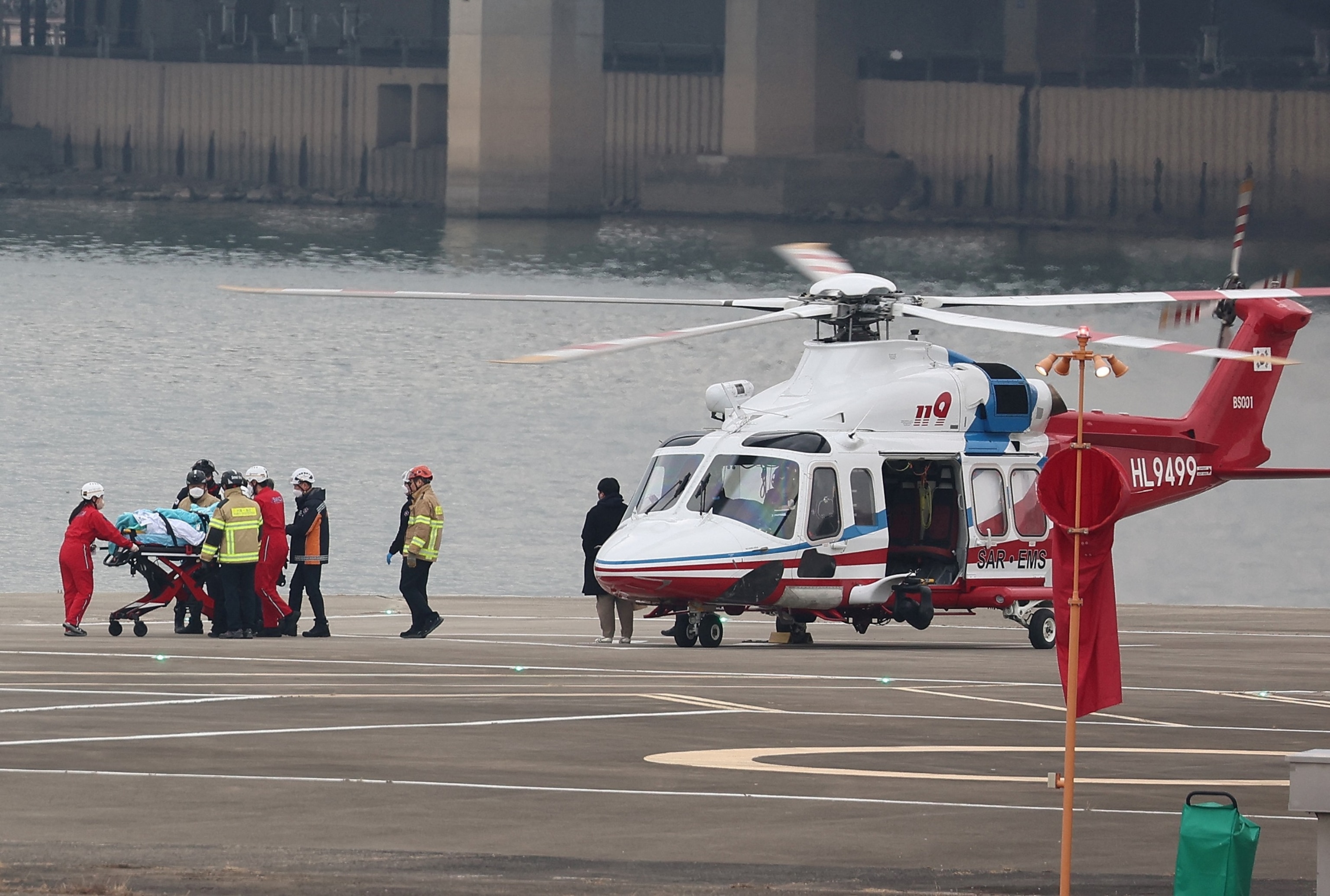 PHOTO: South Korean opposition party leader Lee Jae-myung, who was attacked in Busan, gets off from a helicopter on a stretcher to be transported to Seoul National University Hospital, at a heliport in Seoul on Jan. 2, 2024.