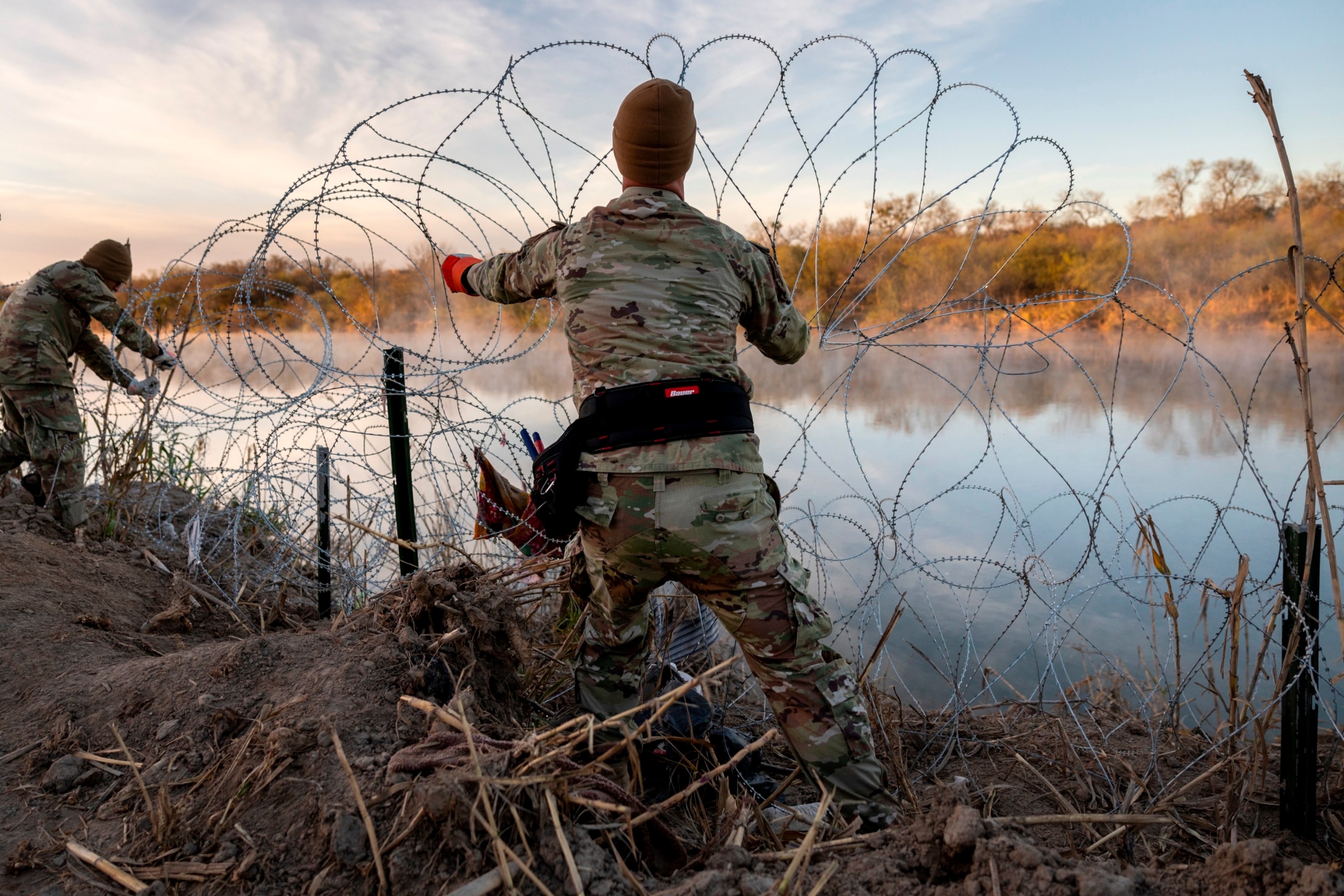 PHOTO: Texas National Guard soldiers install additional razor wire lie along the Rio Grande on January 10, 2024 in Eagle Pass, Texas.