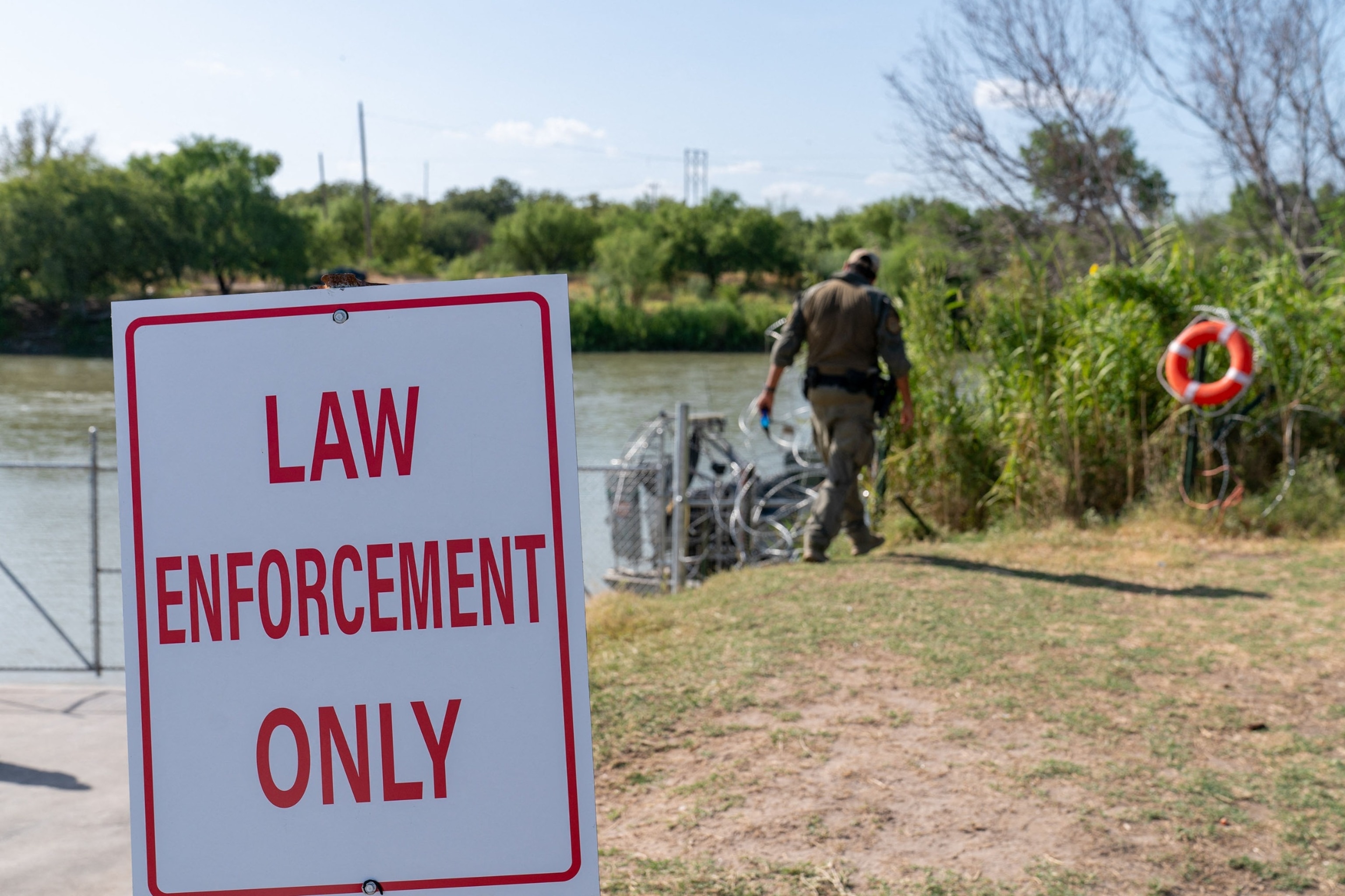 PHOTO: In this Aug. 24, 2023, file photo, law enforcement officials patrol the edge of Eagle Pass' Shelby Park, in Eagle Pass, Texas.