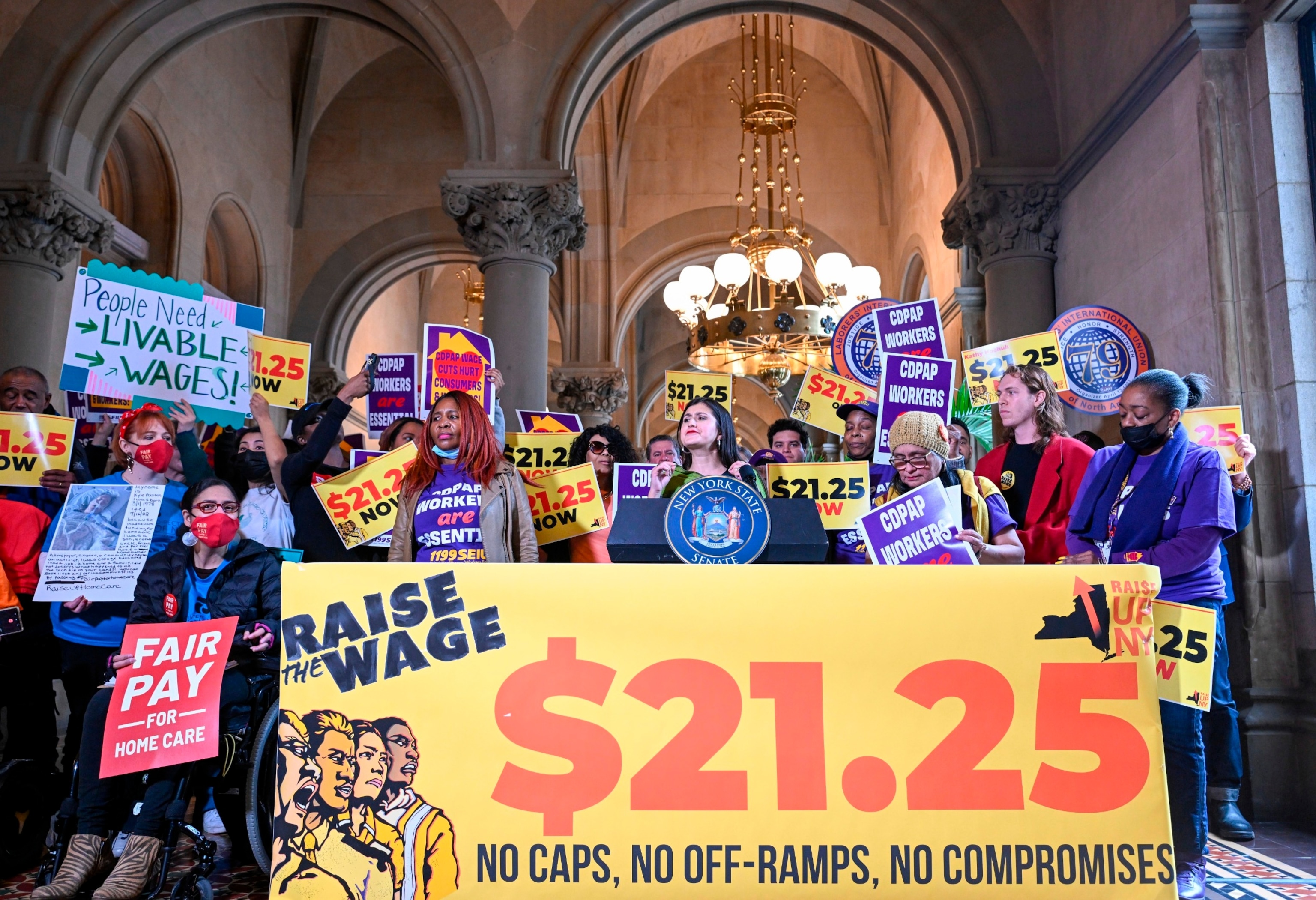 PHOTO: New York Sen. Jessica Ramos stands with protesters urging lawmakers to raise New York's minimum wage during a rally at the state Capitol, March 13, 2023, in Albany, N.Y.