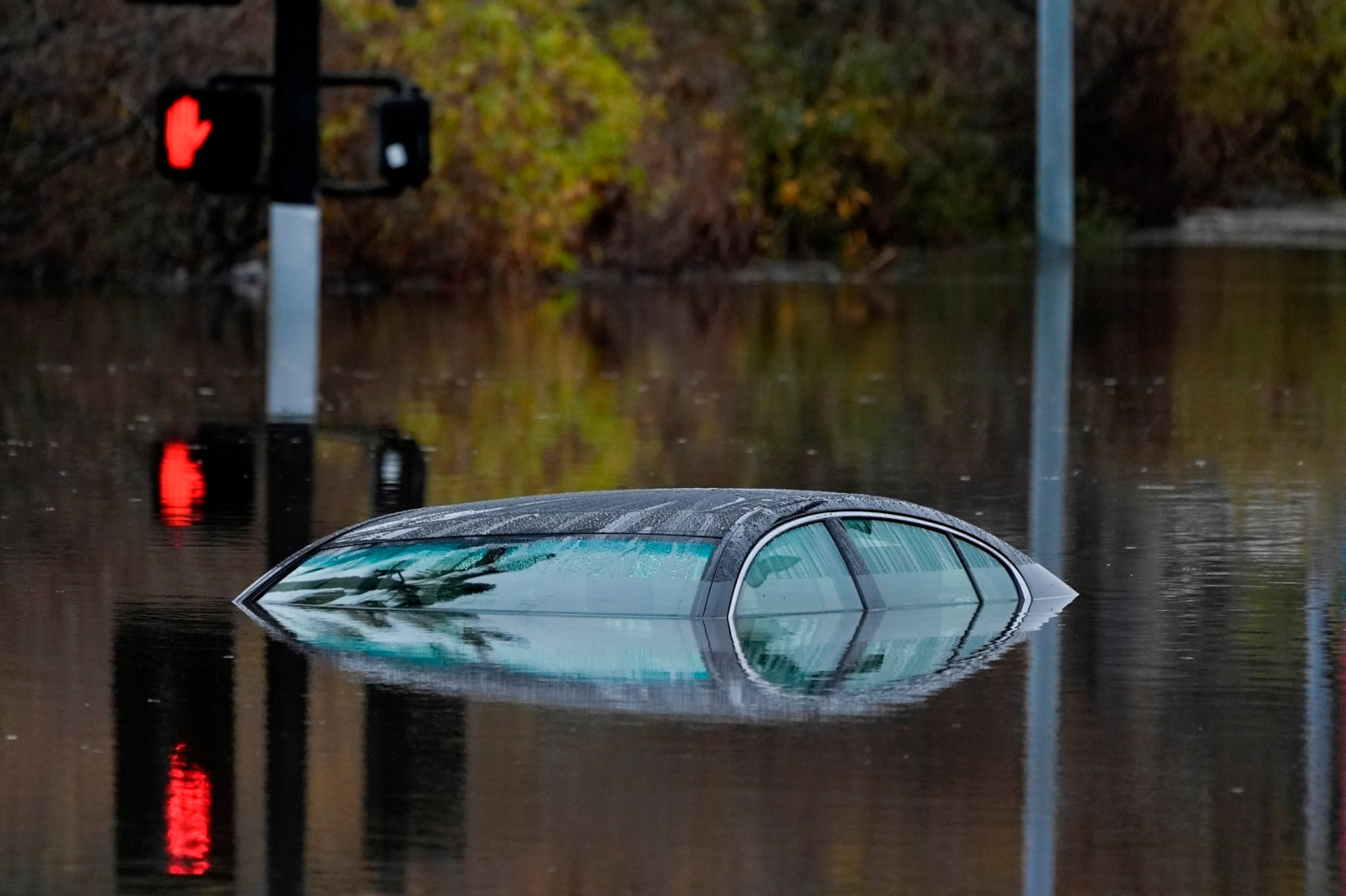 PHOTO: A car sits along a flooded road during a rain storm, Jan. 22, 2024, in San Diego. 