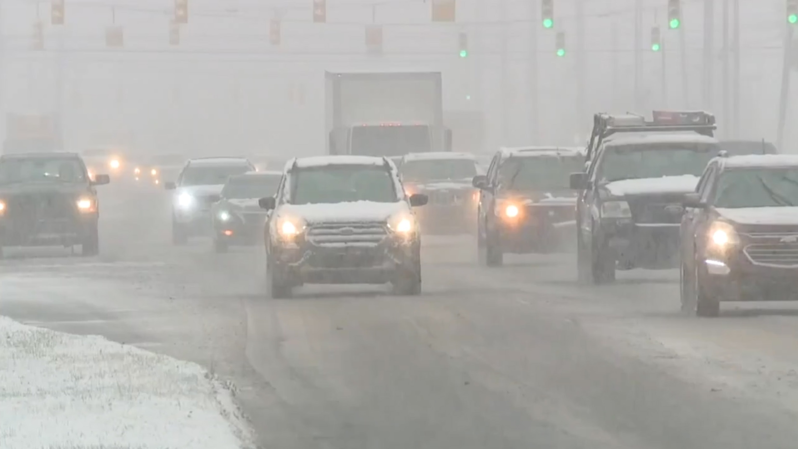 PHOTO: Cars drive through heavy snow, Jan. 22, 2024, in Clawson, Mich.