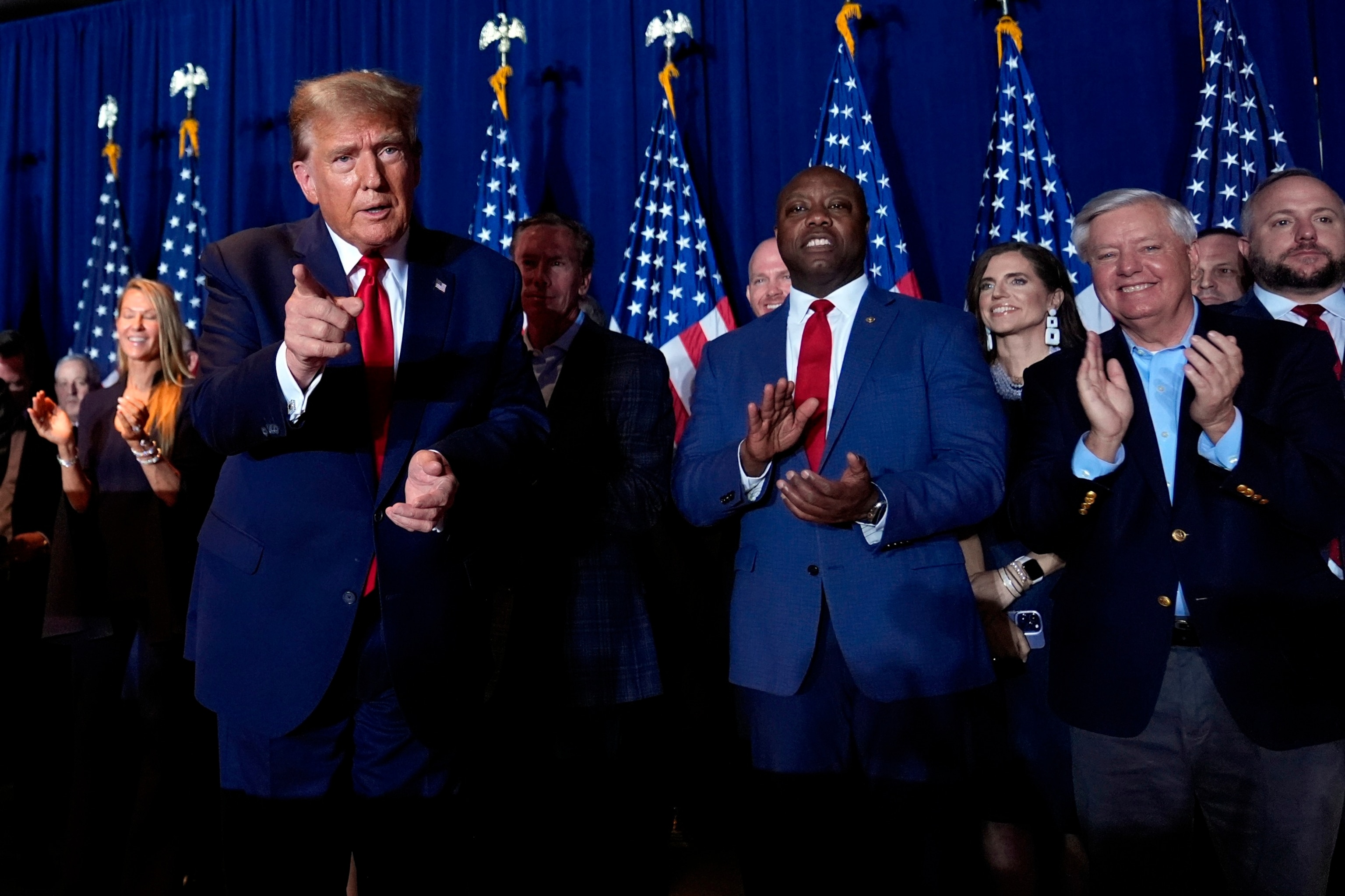 PHOTO: Republican presidential candidate former President Donald Trump attends a primary election night party with Sen. Tim Scott and Sen. Lindsey Graham in Columbia, S.C., Feb. 24, 2024. 