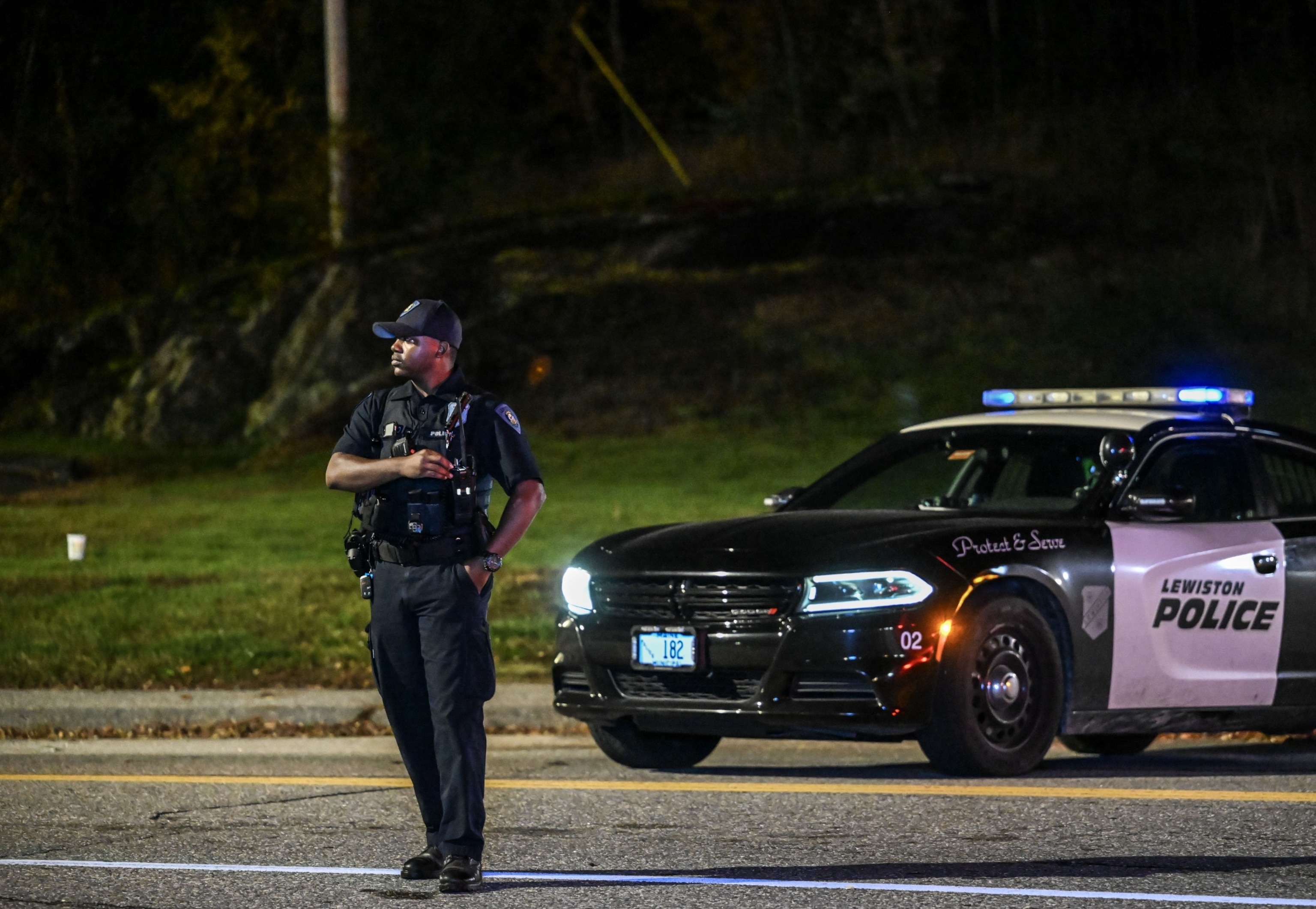 PHOTO: Police officers close the road as they patrol around the street during inspection after a gunman's multiple shootings in Maine, Oct. 26, 2023. 