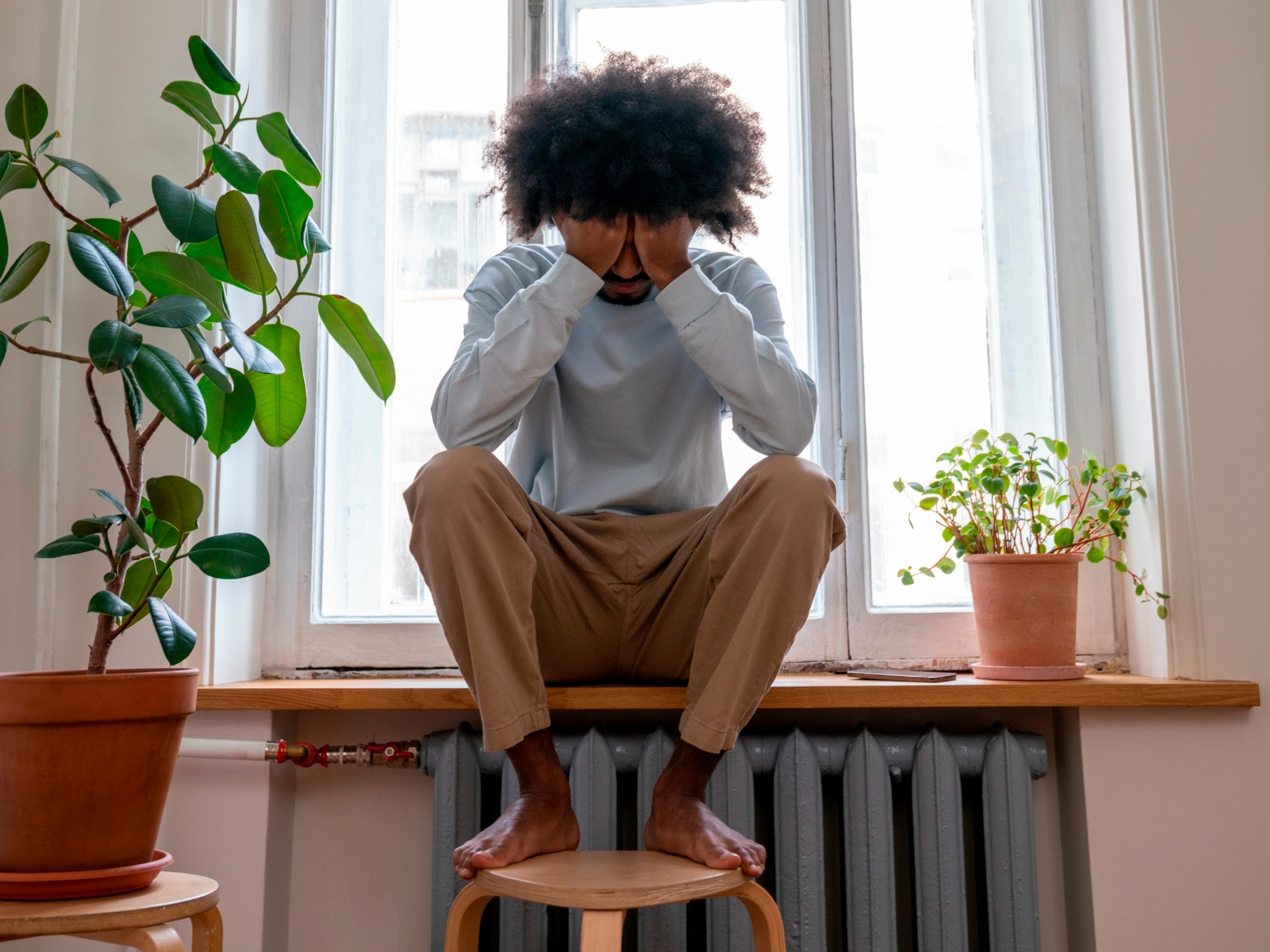 PHOTO: In this undated stock photo, a man is seen resting his head in his hands. 