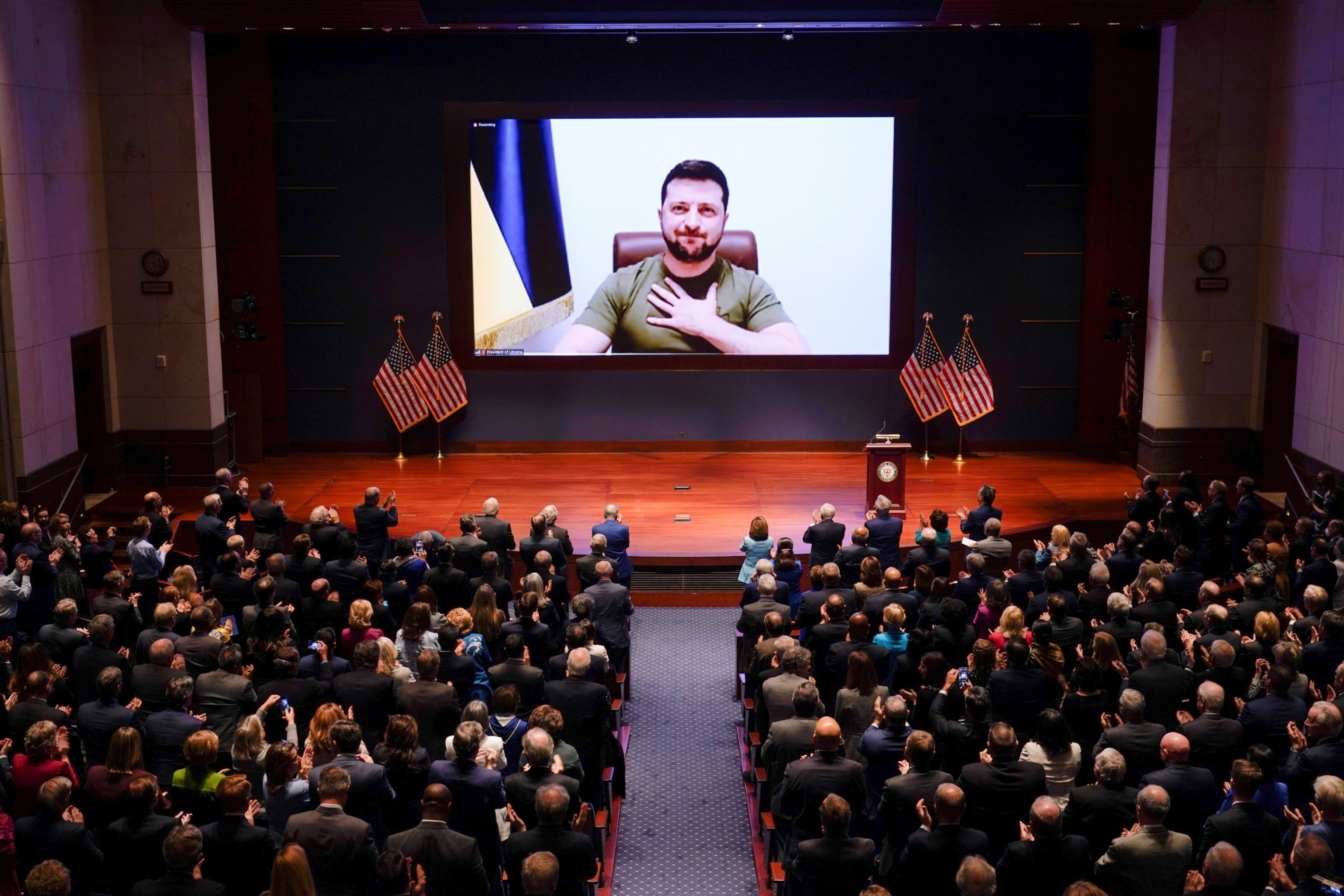 PHOTO: Ukrainian President Volodymyr Zelensky is seen on the screen delivering a speech via videoconference to the U.S. Congress at the Capitol in Washington, D.C., March 16, 2022. 