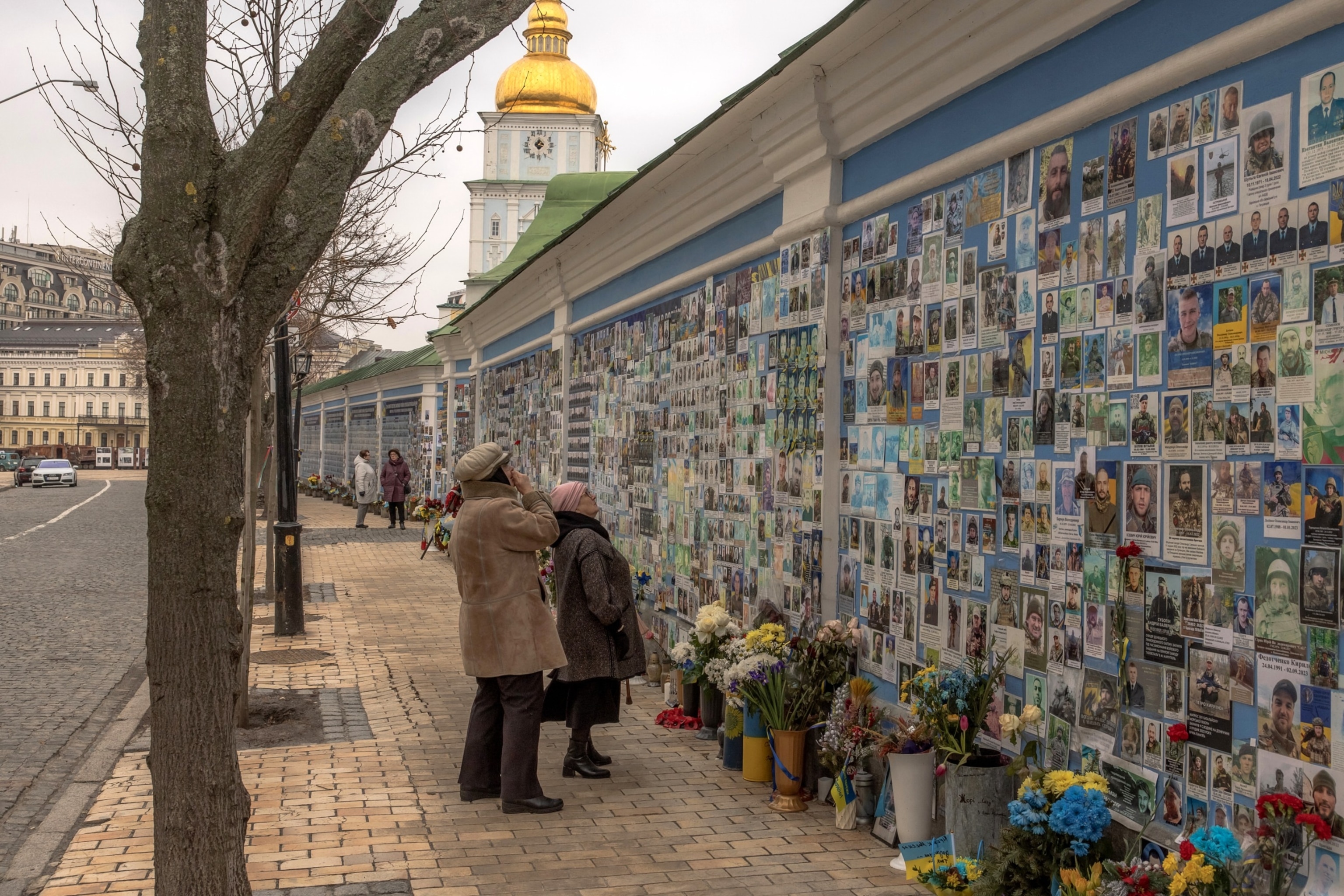 PHOTO: A woman looks at a photo of her son Tymofii Boyko, a Ukrainian soldier who was killed fighting Russian troops, on the "Wall of Remembrance of the Fallen for Ukraine" in downtown Kyiv, on February 23, 2024.