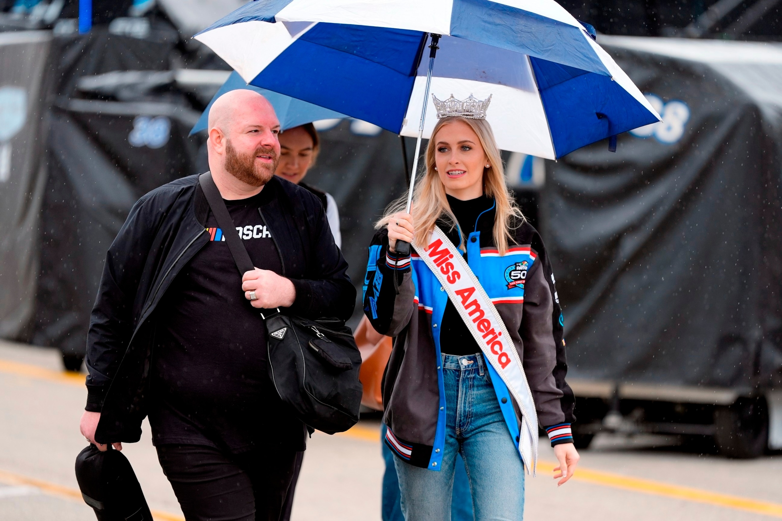 PHOTO: Miss America 2024, Madison Marsh, carries an umbrella before a practice session for the NASCAR Daytona 500 in Daytona Beach, FL, Sat. Feb. 17, 2024.