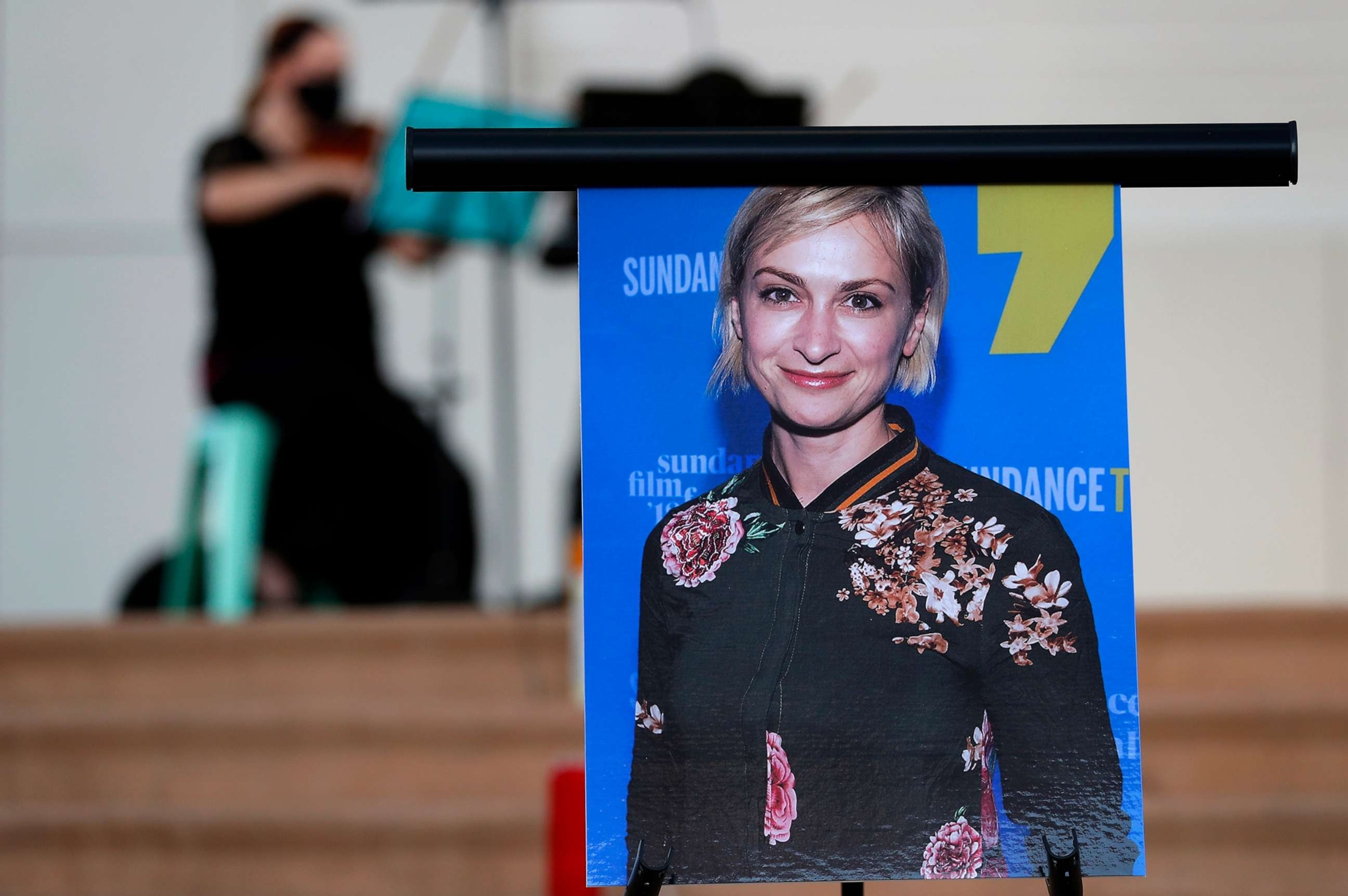 PHOTO: In this Oct. 23, 2021 file photo a musician plays a violin behind a photograph of cinematographer Halyna Hutchins during a vigil in her honor in Albuquerque, N.M.