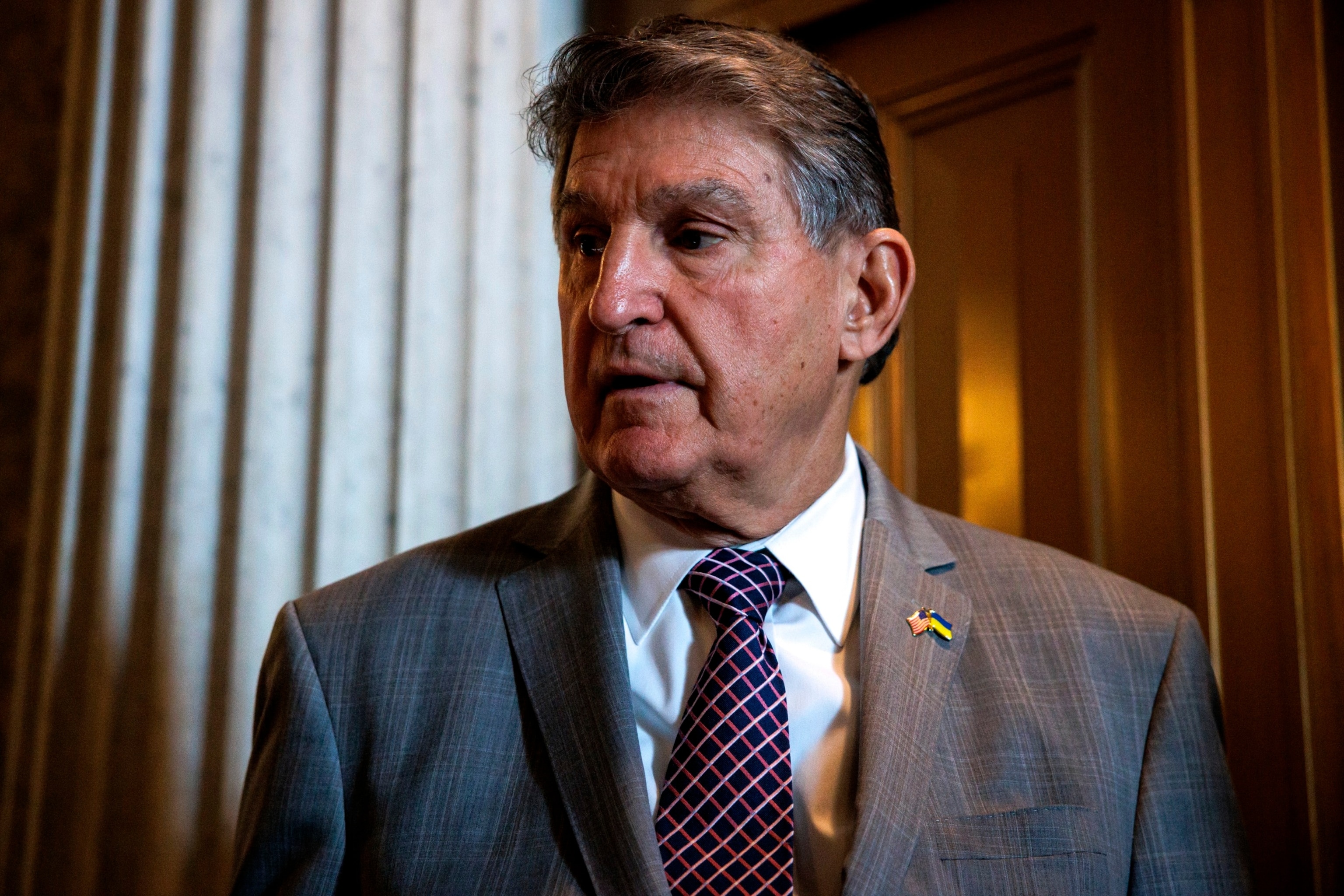 PHOTO: Senator Joe Manchin talks to reporters as he leaves the Senate floor following a vote on January 23, 2024 in Washington, D.C.