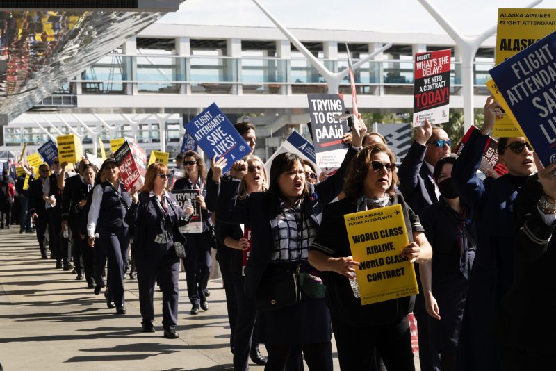 Flight attendants walk picket line at Los Angeles International Airport on Tuesday, Feb. 13, 2024. Flight attendants for major U.S. airlines are holding rallies at airports around the country to push for higher pay. Tuesday's protests are not, however, a strike. Federal law makes it difficult for airline unions to go on strike. (AP Photo/Richard Vogel)