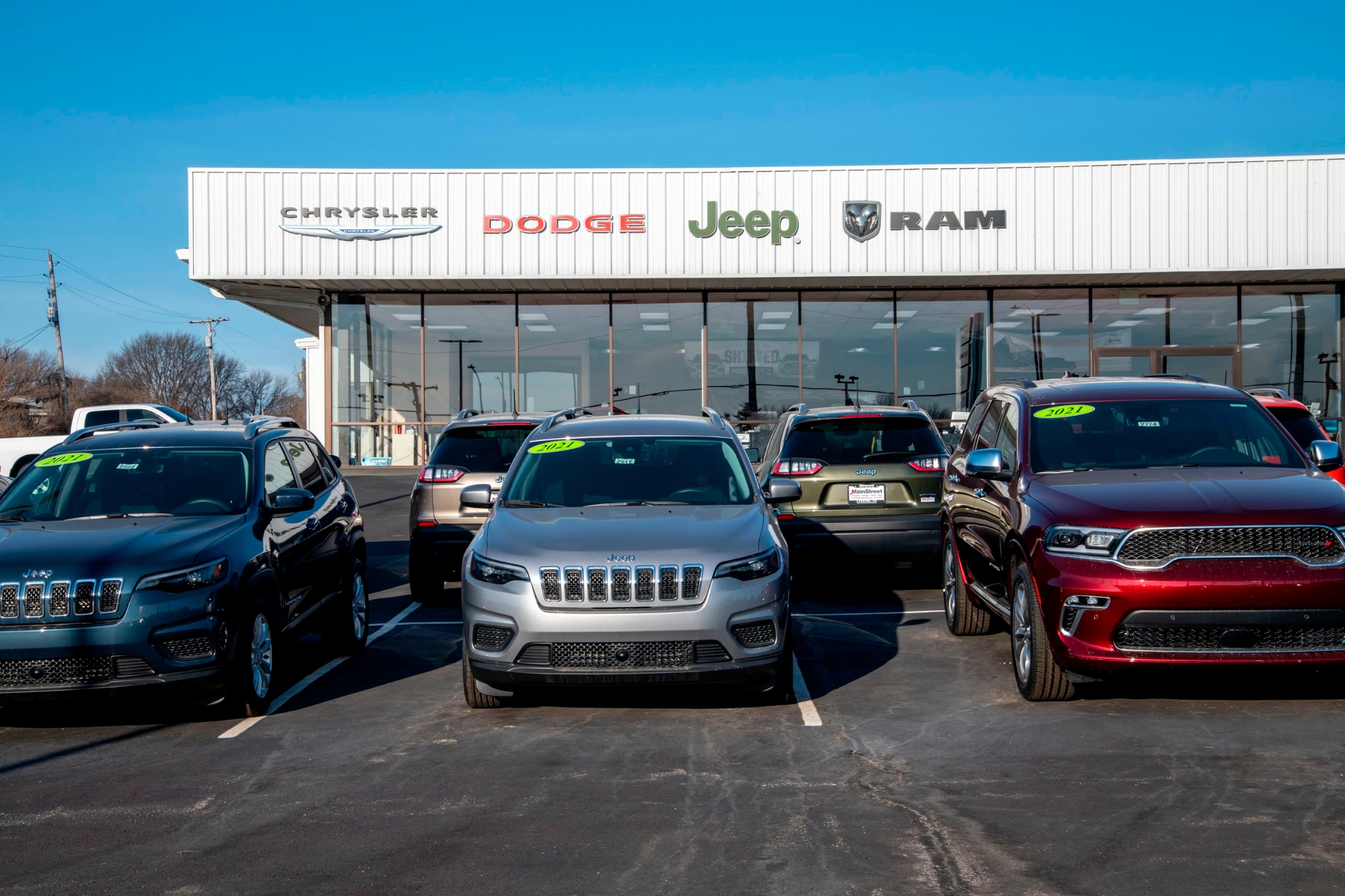 PHOTO: In this March 7, 2021, file photo, a car dealership displays vehicles on the lot in Lansing, Kansas.