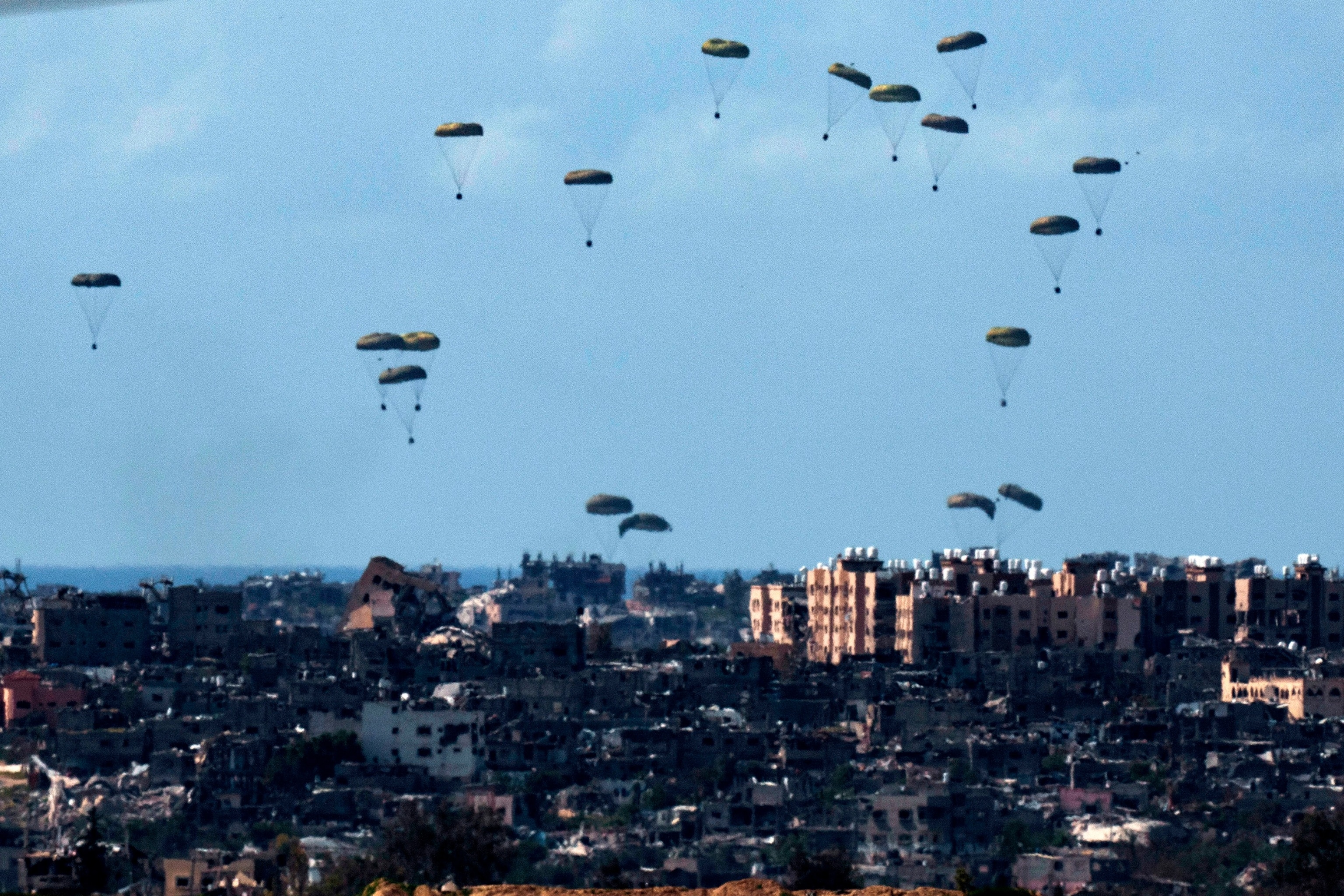 PHOTO: Parachutes drop supplies into the northern Gaza Strip, as seen from southern Israel, on March 8, 2024.