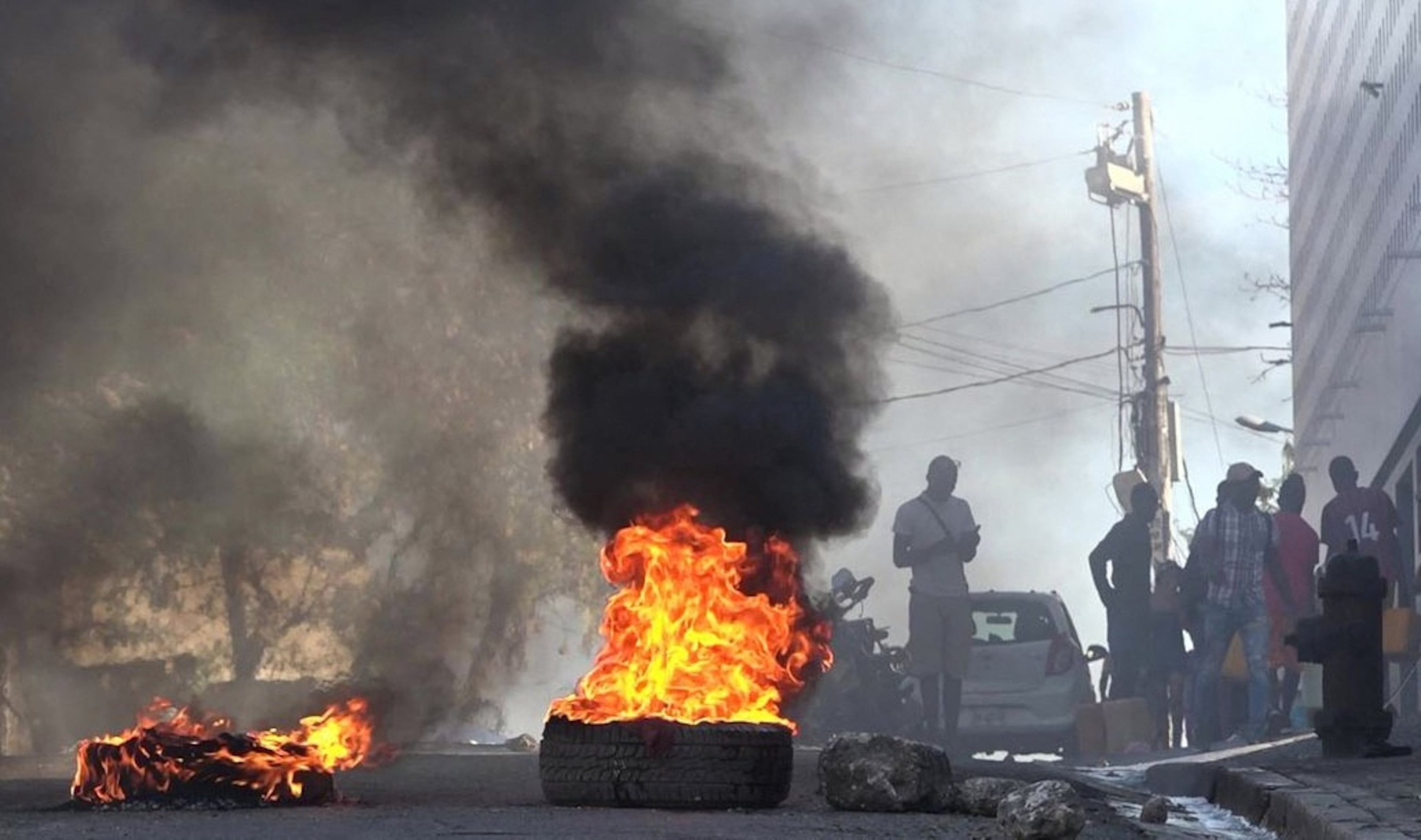 PHOTO: This screen grab taken from AFPTV shows tires on fire near the National Penitentiary in Port-au-Prince, Haiti, on March 3, 2024, after armed gangs attacked the country's largest prison and freed scores of inmates.