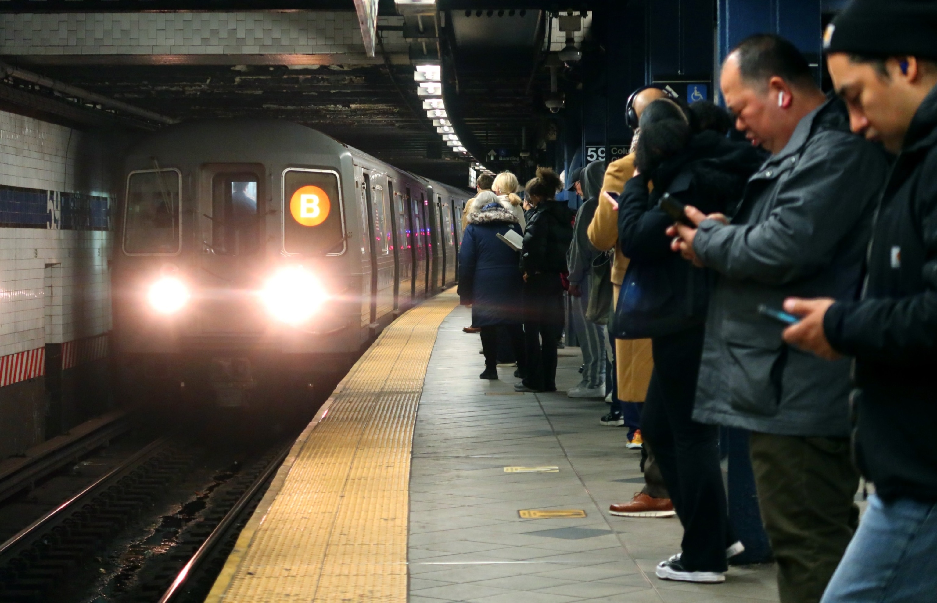 PHOTO: People wait to board a B line subway train at the Columbus Circle - 59th Street station on February 26, 2024, in New York City.