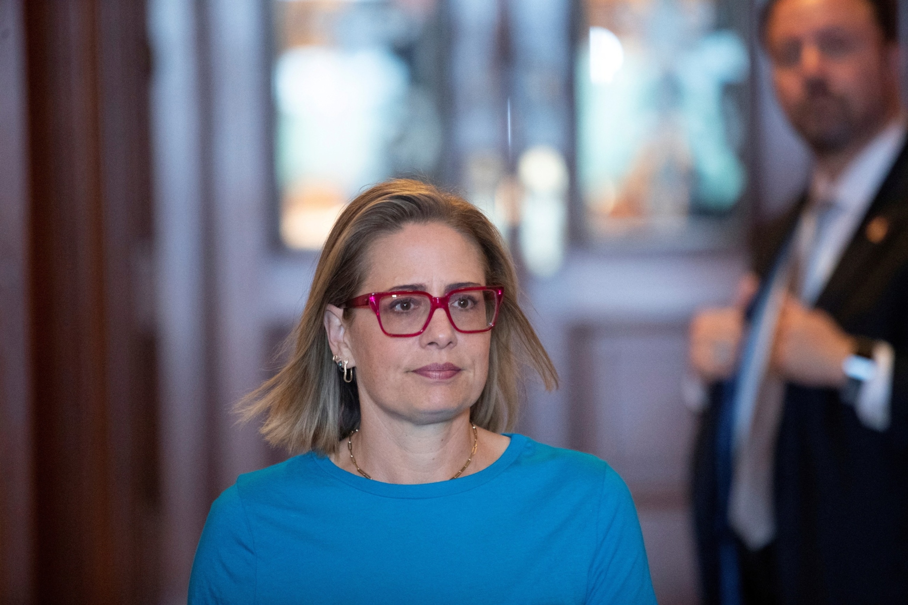 PHOTO: Senator Kyrsten Sinema walks to an elevator outside the Senate Chamber during a vote on Capitol Hill in Washington, May 19, 2022. 