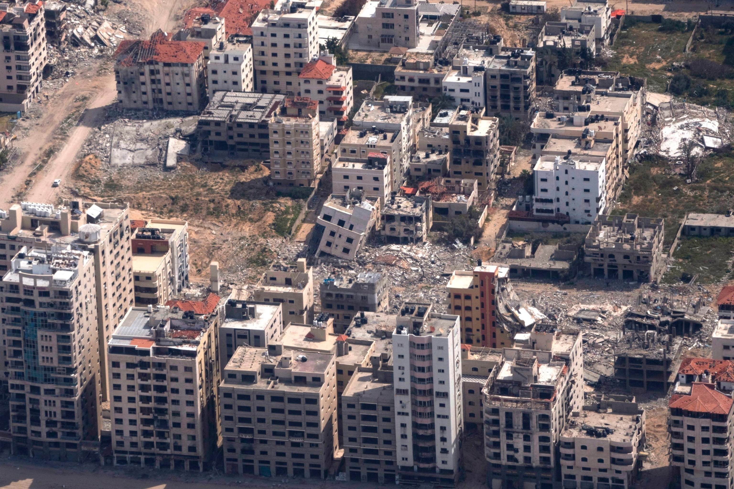 PHOTO: Destroyed buildings are seen through the window of a U.S. Air Force airplane flying over the Gaza Strip, Mar. 14, 2024. 