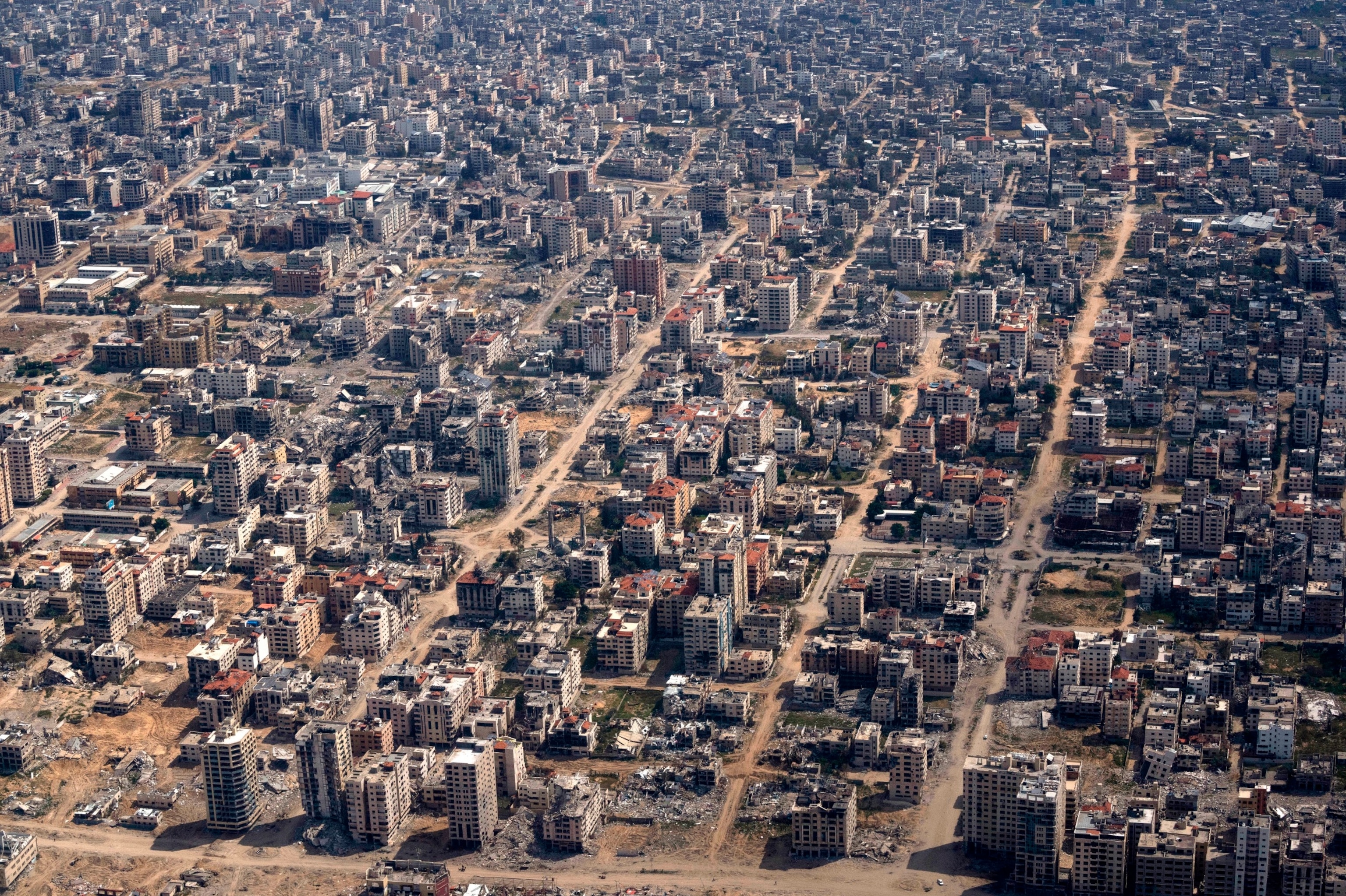 PHOTO: Destroyed buildings are seen through the window of a U.S. Air Force airplane flying over the Gaza Strip, Mar. 14, 2024. 