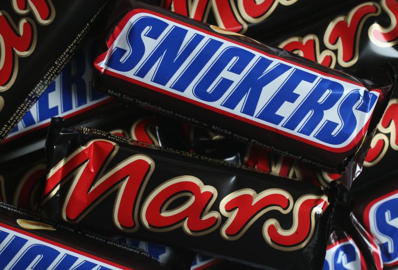 BERLIN, GERMANY - FEBRUARY 23: In this photo illustration Snickers and Mars chocolate bars lie on a table on February 23, 2016 in Berlin, Germany. The Mars company, which owns both brands, has announced a recall of chocolate products in 55 countries following the discovery of bits of plastic in a chocolate bar produced in one of the company's plants in Holland. (Photo by Sean Gallup/Getty Images)