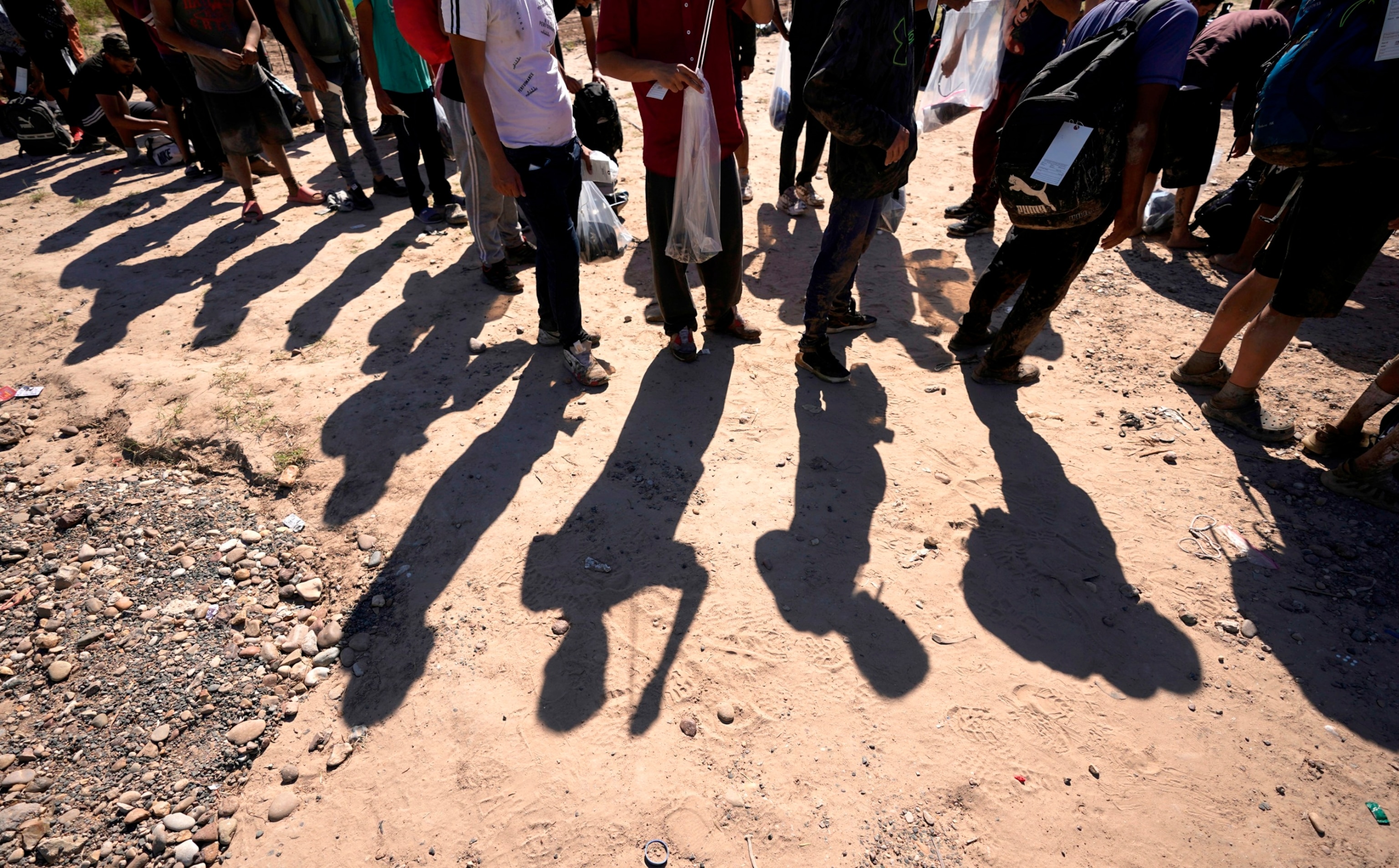 PHOTO: Migrants wait to be processed by the U.S. Customs and Border Patrol after they crossed the Rio Grande and entered the U.S. from Mexico, Oct. 19, 2023, in Eagle Pass, Texas.