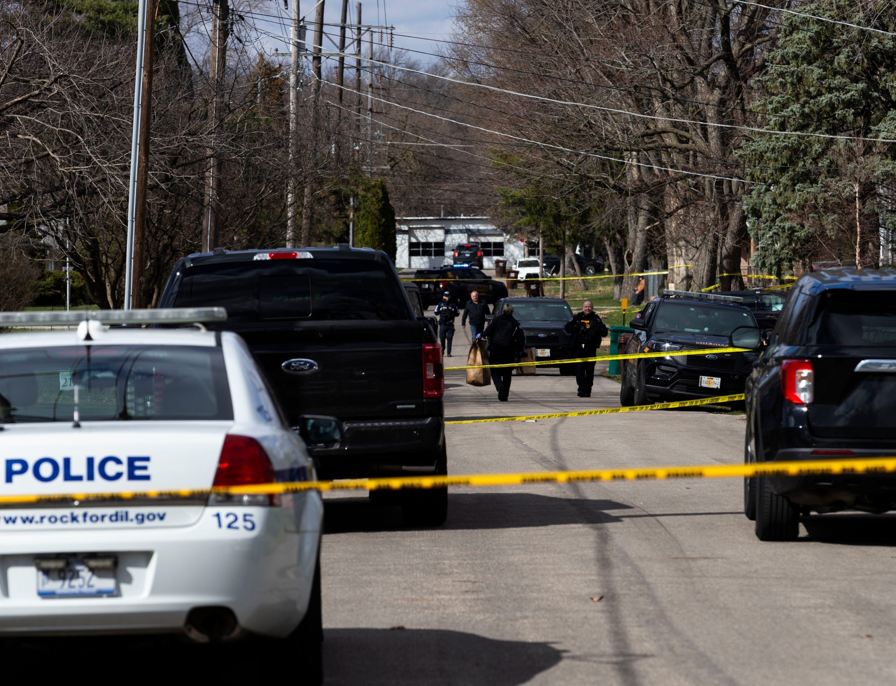 PHOTO: An officer brings out bags of evidence after a stabbing incident on March 27, 2024, near Cleveland Avenue in Rockford, Ill.