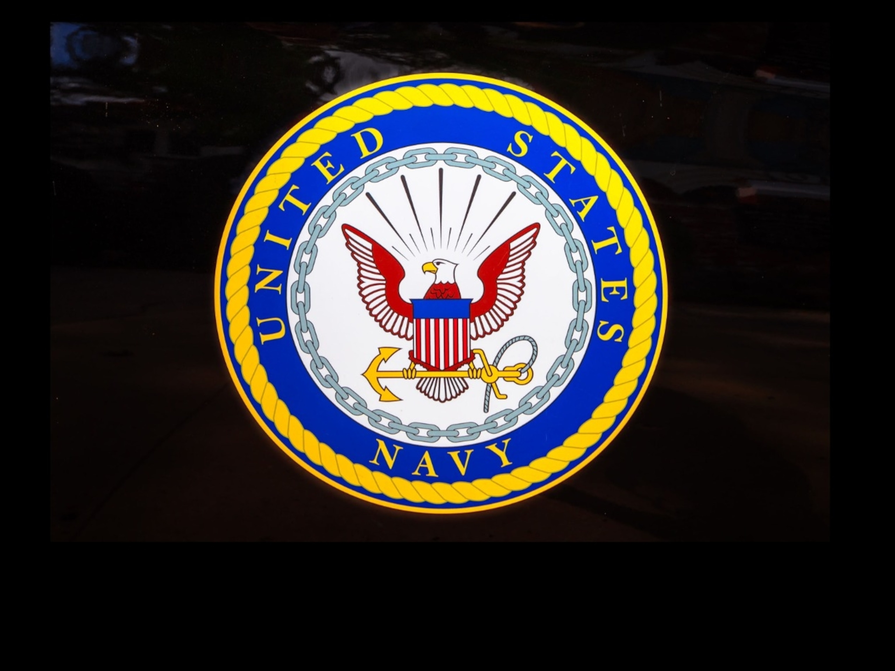 PHOTO: San Diego, Navy pier, California, UNITED STATES - August 3, 2018: Emblem of the United States Navy isolated on a door of black car of United States Armed Forces.