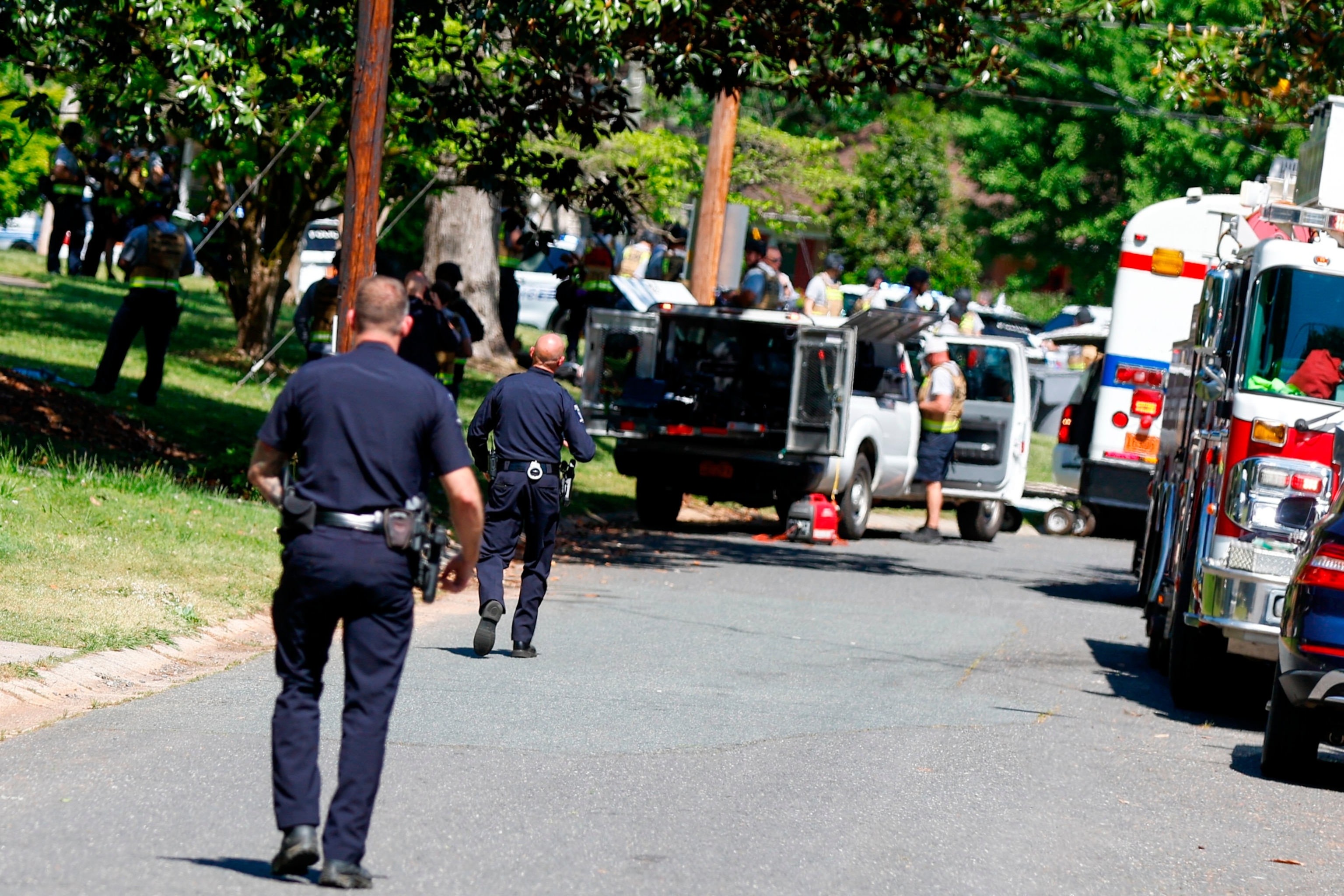 PHOTO: Charlotte Mecklenburg Police Department officers walk in the neighborhood where an officer-involved shooting took place in Charlotte, N.C., April 29, 2024.